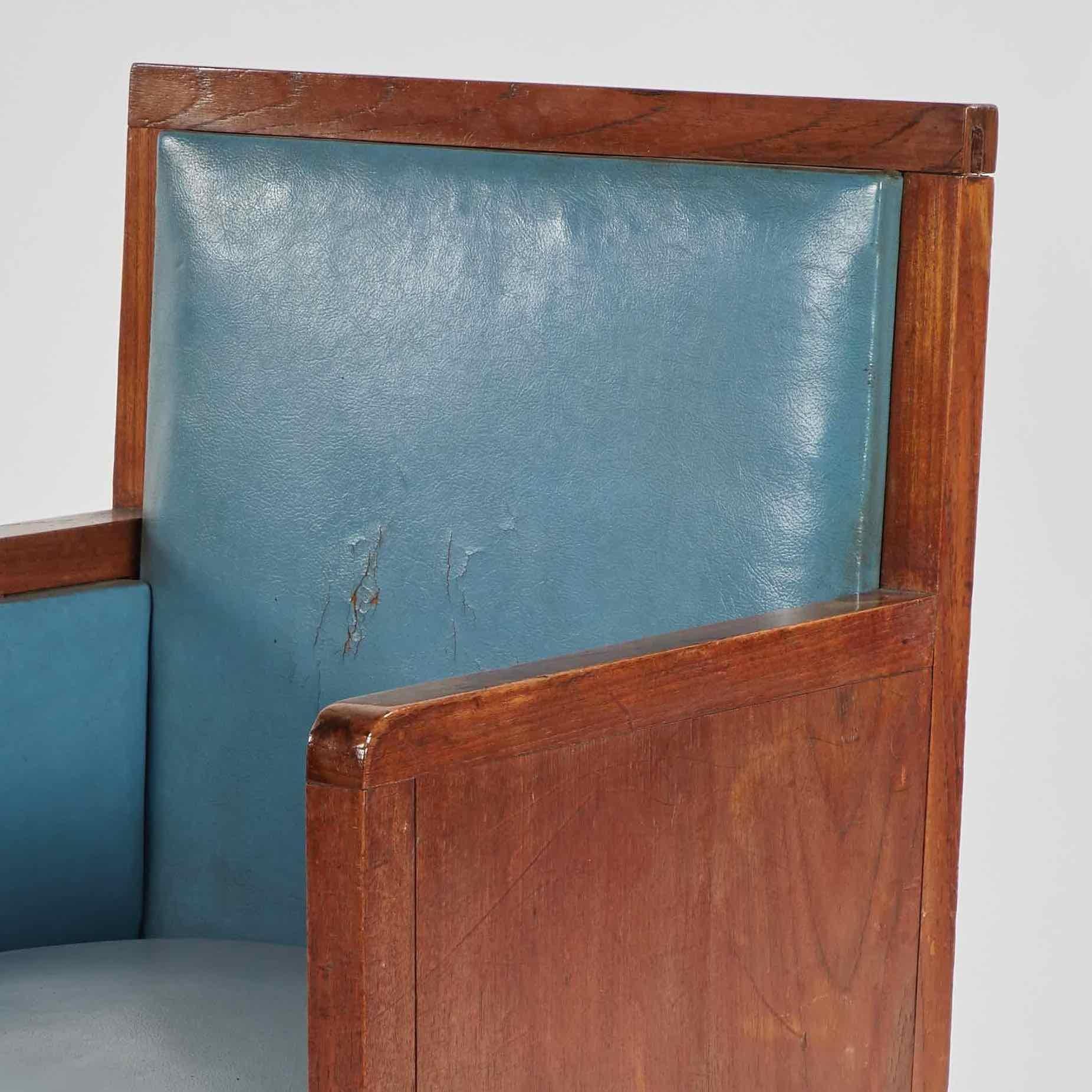 Art deco wooden armchair upholstered in blue leather from France. 