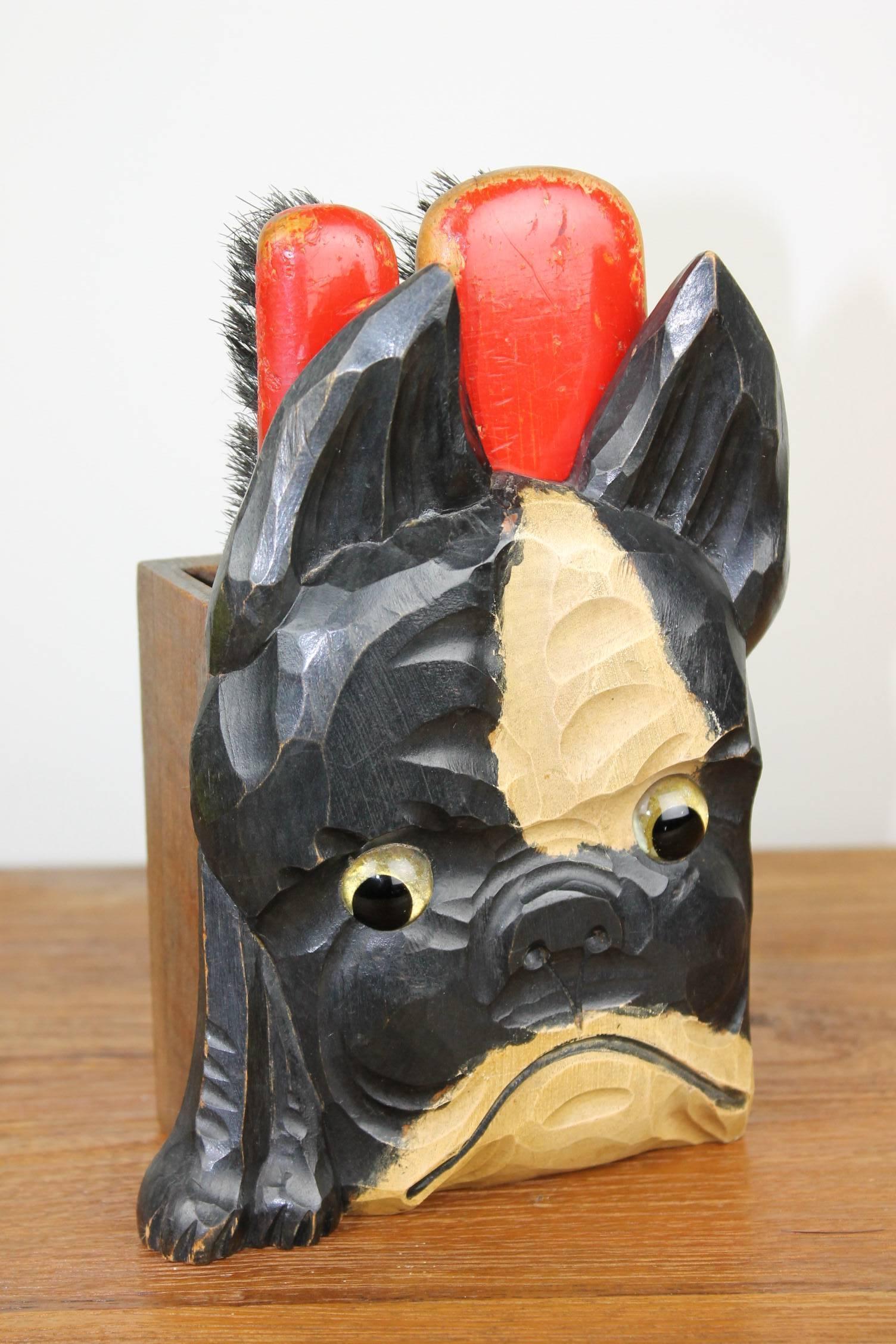 Cute 1930s wooden bulldog brush holder set. This hand-carved black and white dog figural with double brush holder and big eyes has two red original brushes. He's looking for a new spot in a French bulldog collection or in a brush holder collection.