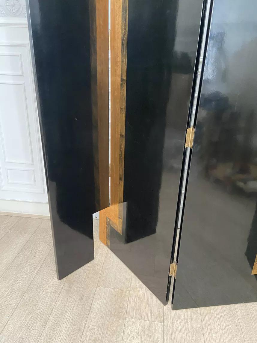 Art deco-style black and gold lacquered screen produced by compagnie du pacifique.