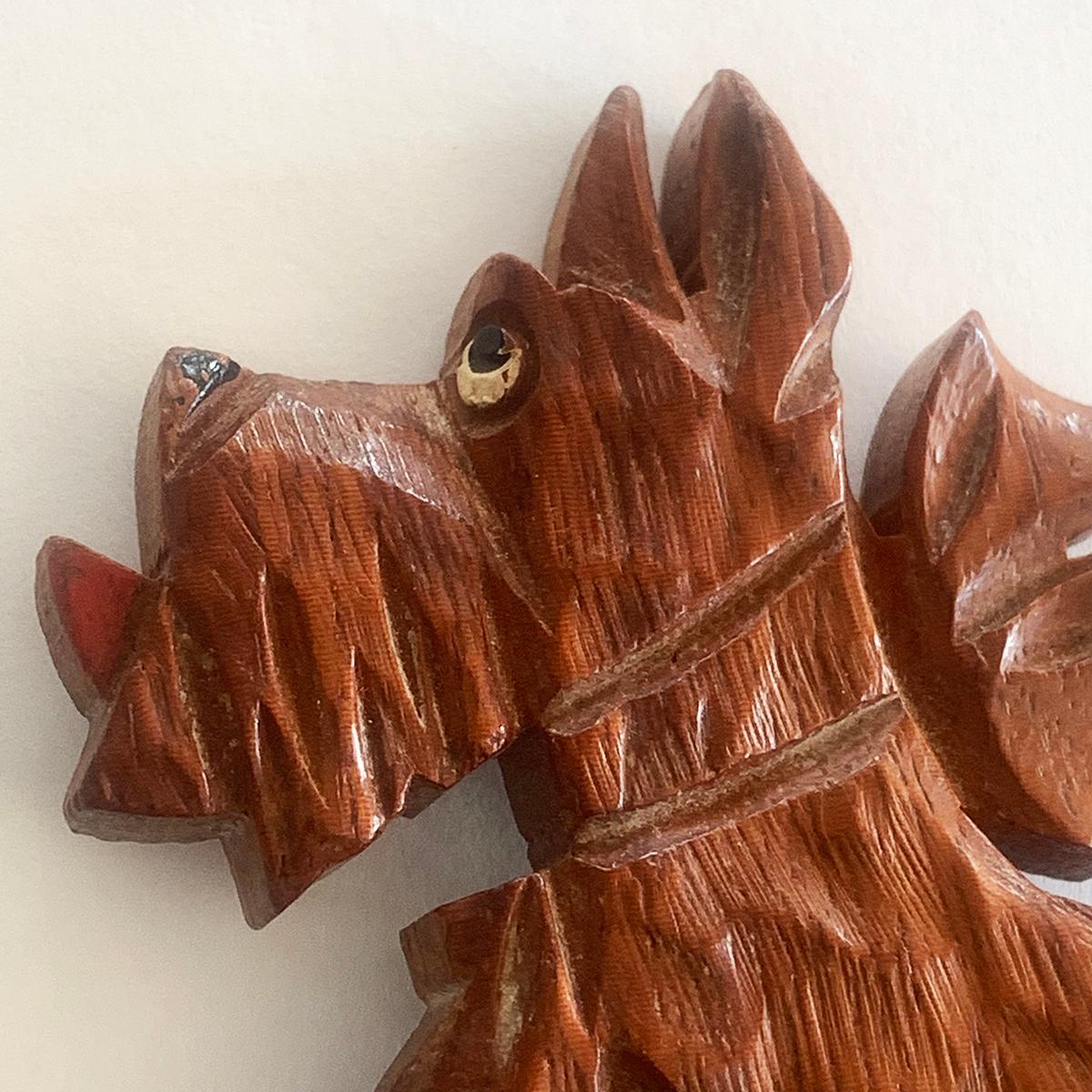 Art Deco Brooch Carved Wooden Scottish Terrier, with details painted for tongue, nose and eye. Finely detailed, with collar and bow to neck. The rear clasp has the old French “Roll-over” safety clasp in excellent condition. A lovely piece of comedy,