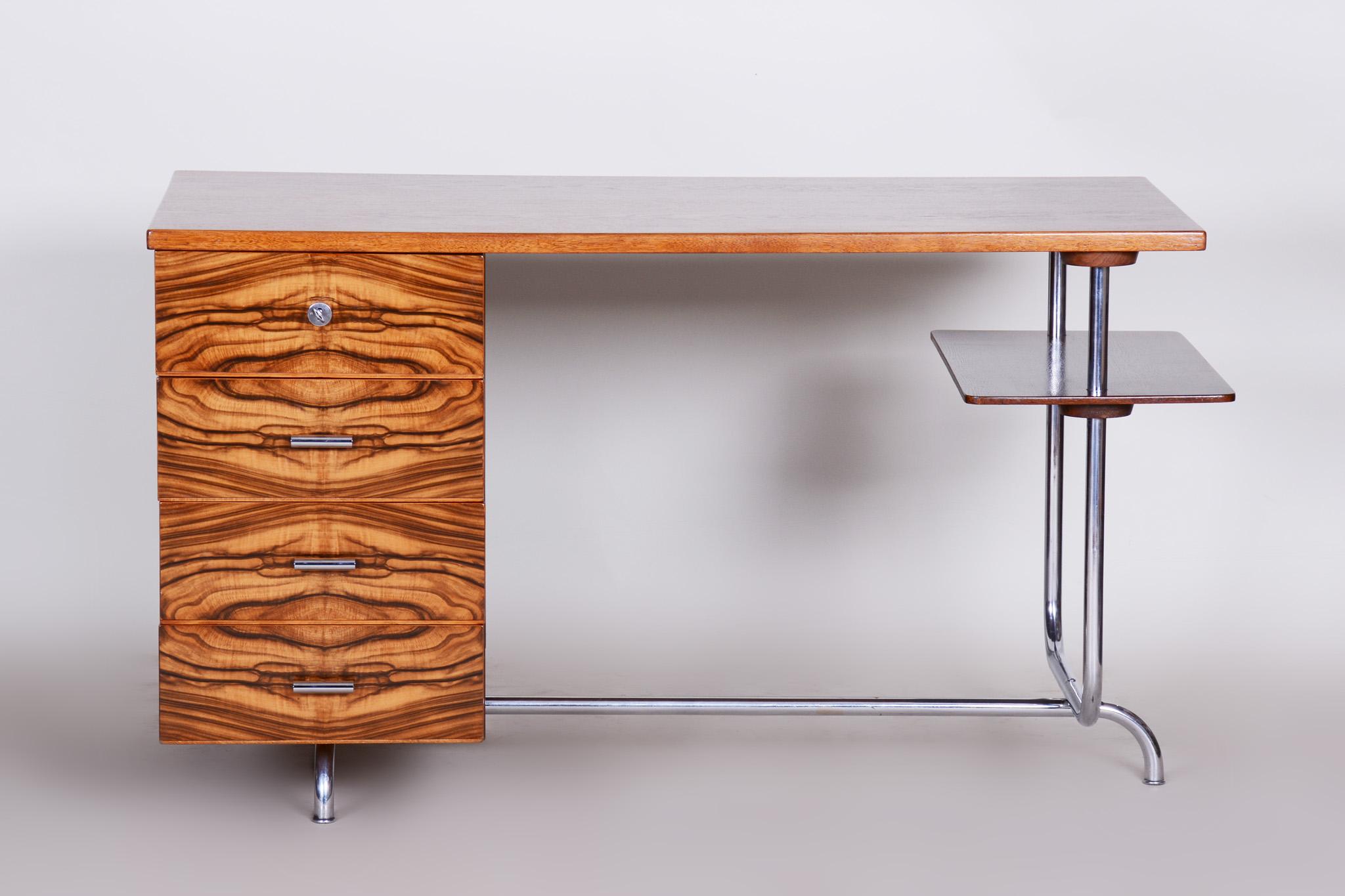 One of the most successful writing desk made in United Arts & Crafts Manufacture (UP) in Brno.
Designed by Czech architect Jindrich Halabala.
Material: Walnut, oak and chrome-plated steel
Completely professionally restored.

Original catalog