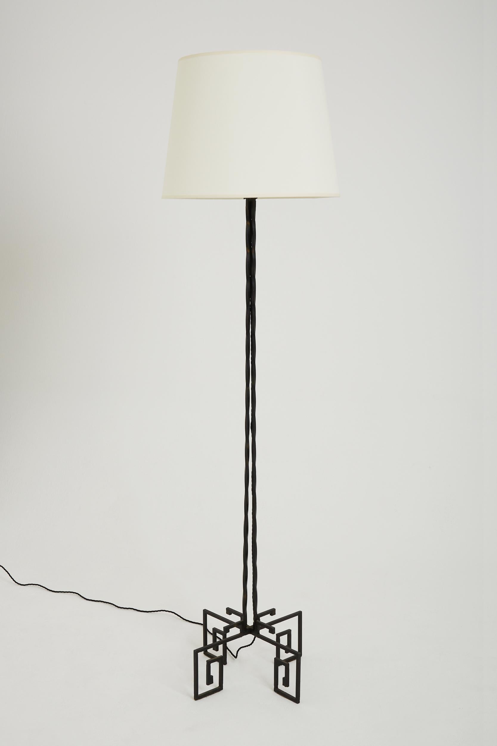 An Art Deco black wrought iron floor lamp, the twisted square-sectioned structure on a greek keep quadripod base.
France, Circa 1930.
With the shade: 190 cm high by 50 cm diameter.
Lamp base only: 156 cm high by 46 cm square.
