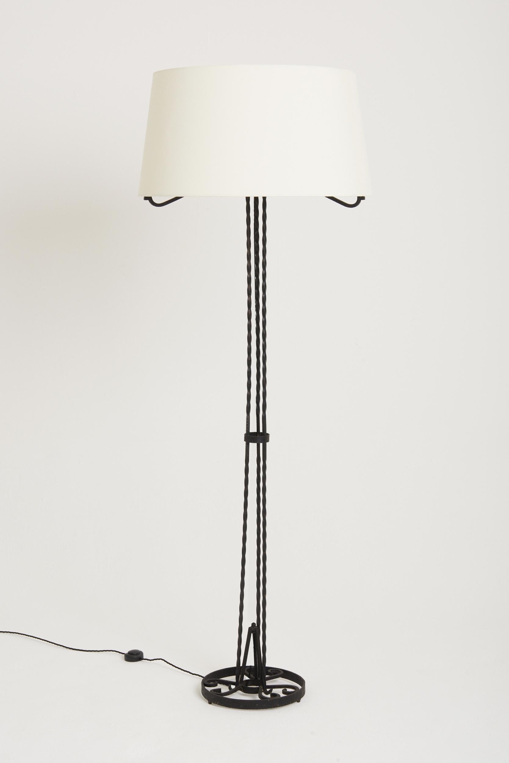 An Art Deco tall wrought iron floor lamp. With its original shade recovered in new off white fabric.
France, Circa 1925.
 