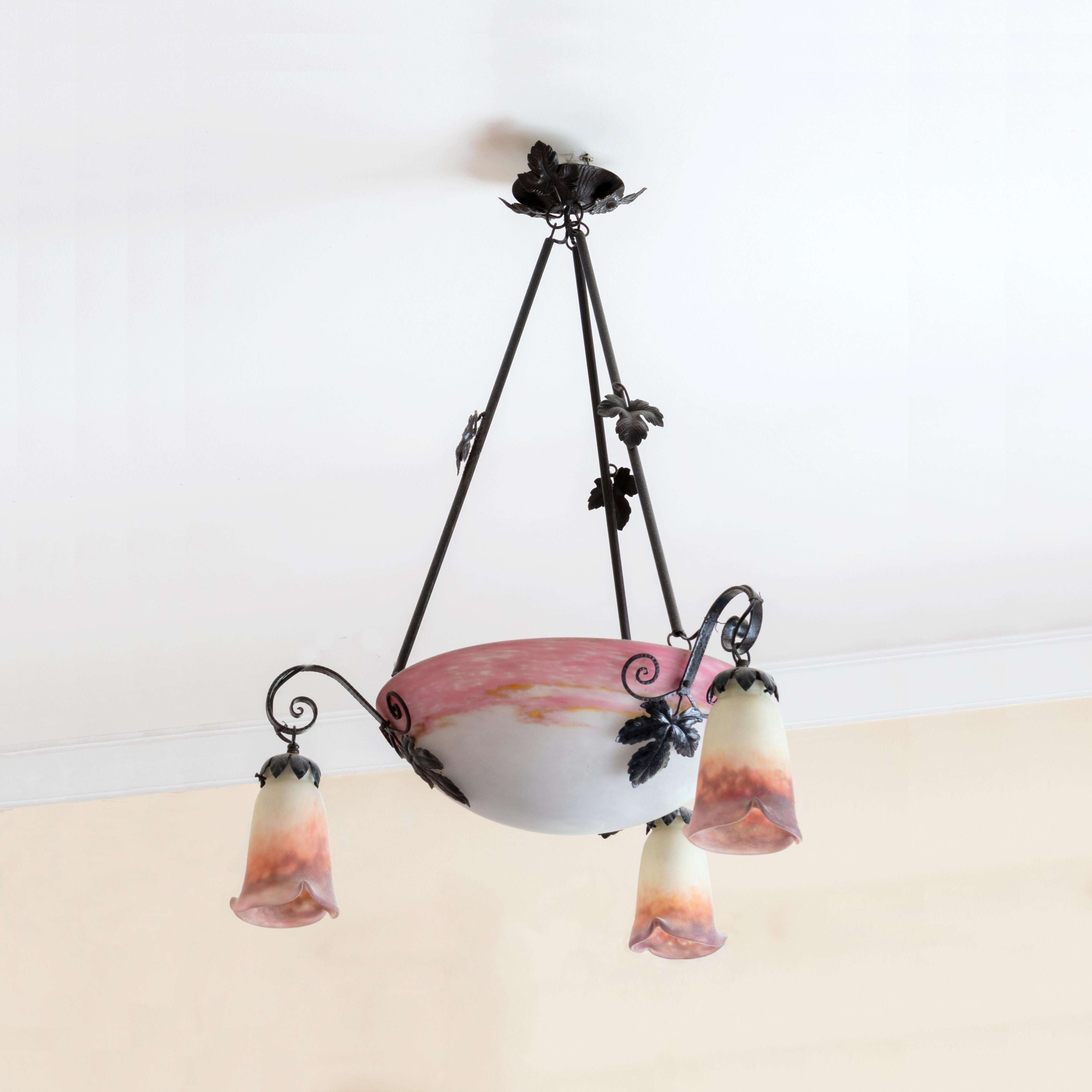 A central bowl shade with fitments that support the three satellite shades and rods for suspension,  ironwork rods decorated with rose motifs.

The chandelier is currently wired for both European Union and US standards LED lights. The LED lamp bulbs