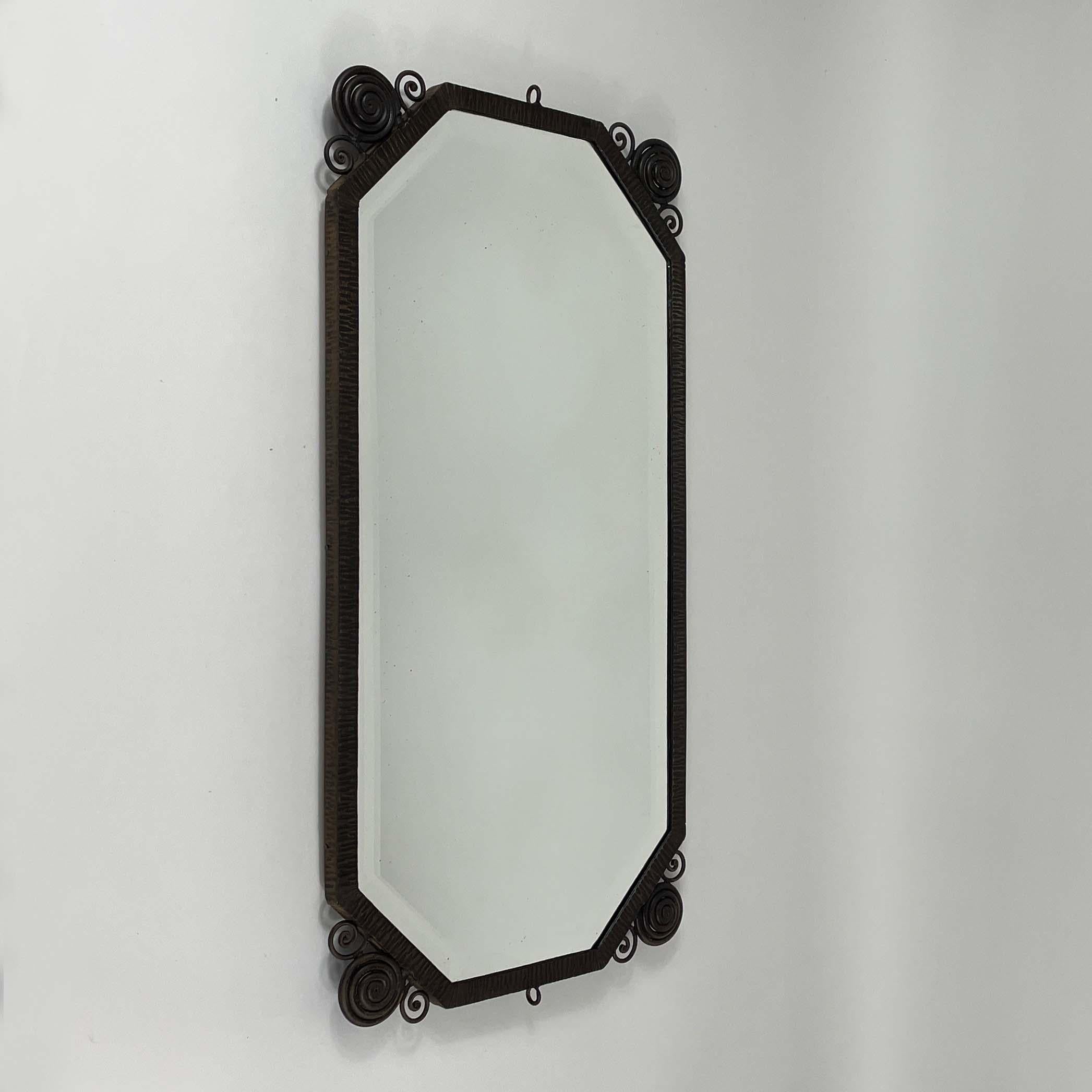 This unusual wall mirror was designed and manufactured in France in the 1920s to 1930s in the manner of designs by Edgar Brandt, René Prou or Charles Schneider .

This mirror is an elegant, vintage piece featuring a frame made of intricately