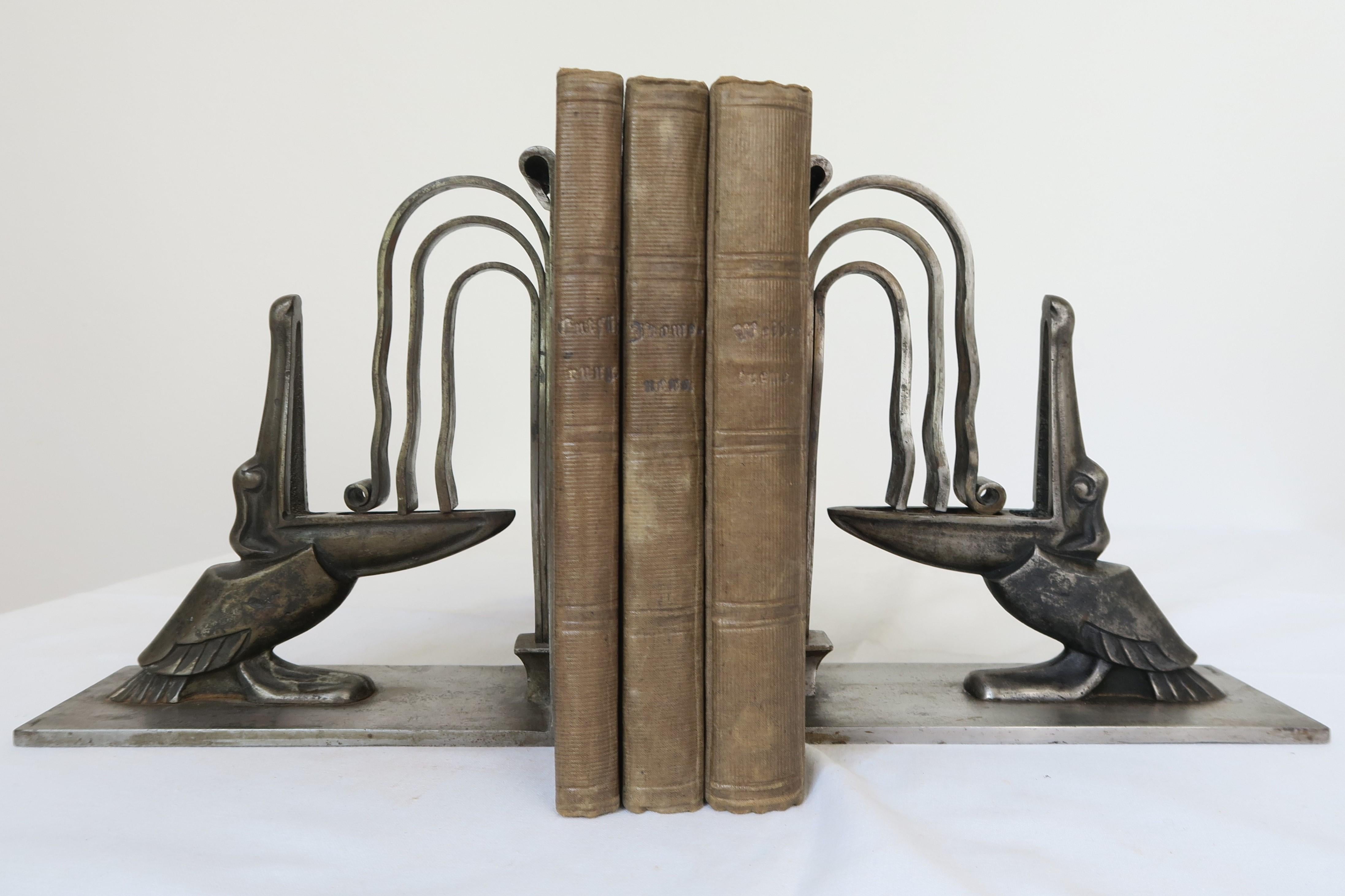 For sale is a unique pair of Art Deco bookends by Edgar Brandt (1880-1960). They are wrought iron and each modelled as pelicns with open beaks catching a fountain of water.
They are in excellent, original condition. No modifications or restorations