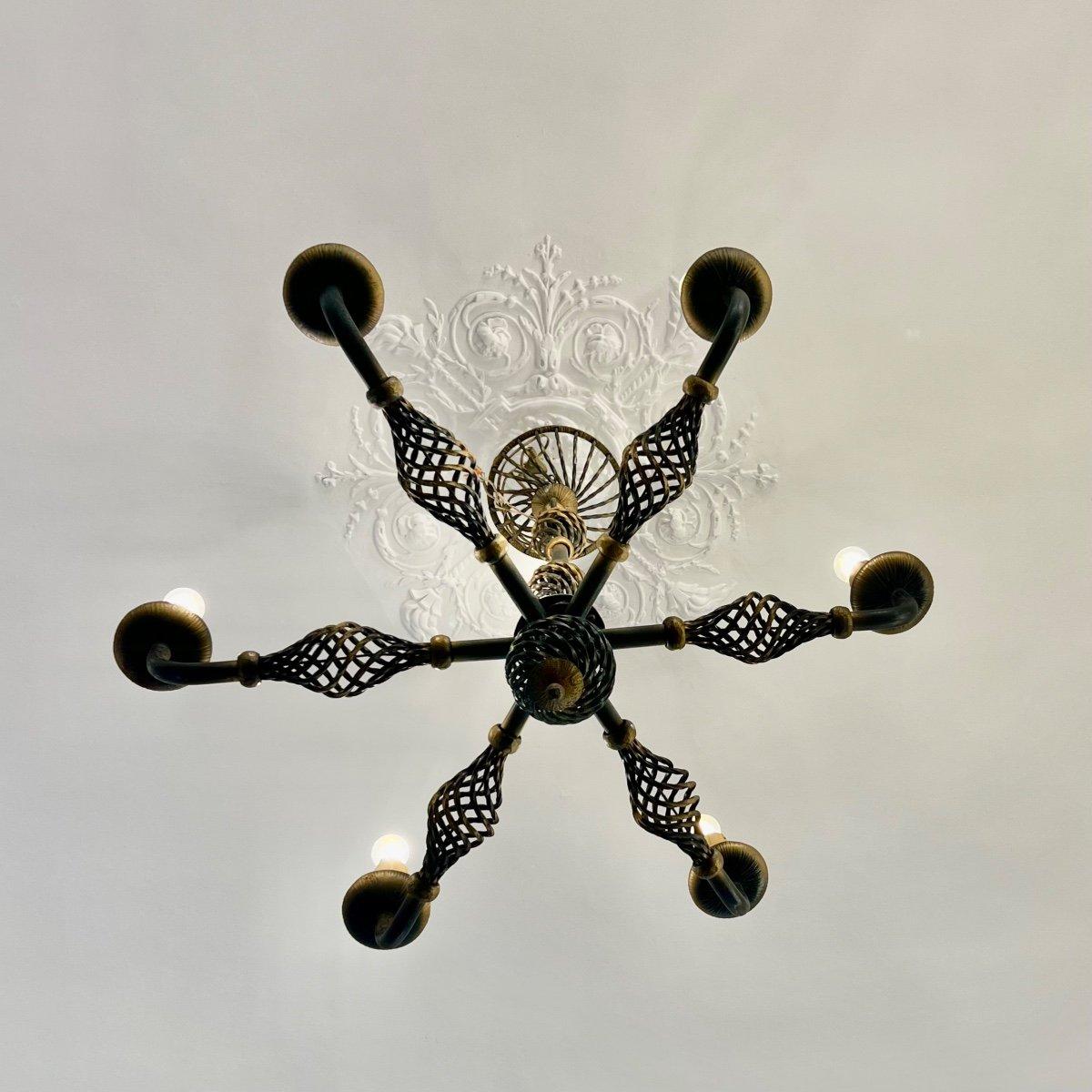 This stunning Art Deco chandelier made from wrought iron dates back to 1940. It is elegantly patinated and comes equipped with six 4w LED lamps, making it ready for installation. The dimensions are 90x90 cm.