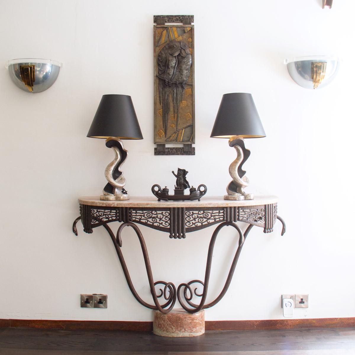 An exceptional, rare wrought iron console with a pink Campana marble top on four uprights, representing coiling snakes. It is encircled by stylised floral motif fretwork, vertical bands and hammered spheres, circa 1925.

Michel Zadounaïsky