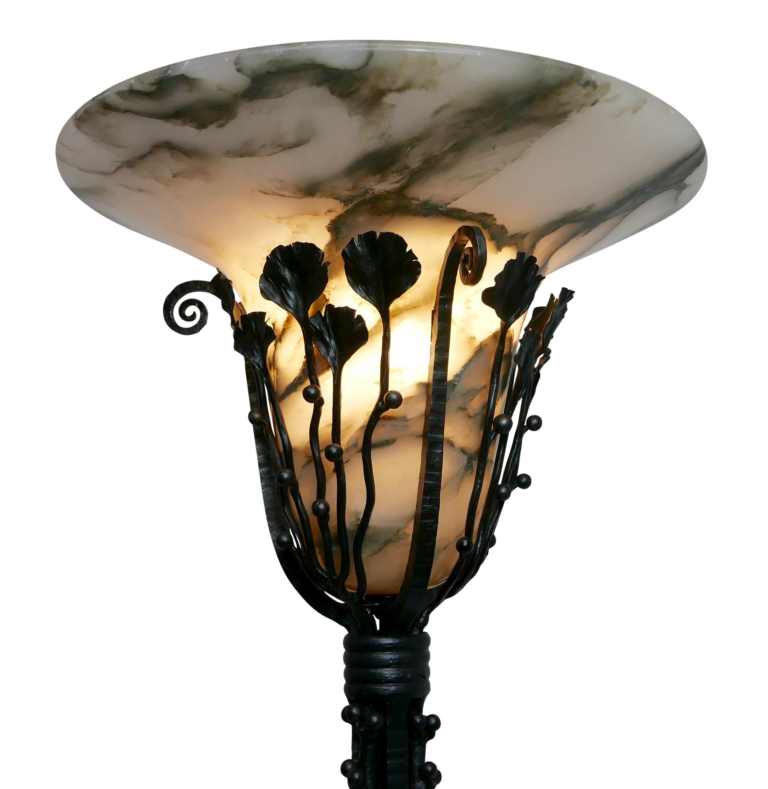 Wrought iron floor lamp in the manner of Paul Kiss with original black and white alabaster shade. Recently refurbished and rewired.
France, circa 1920.
 