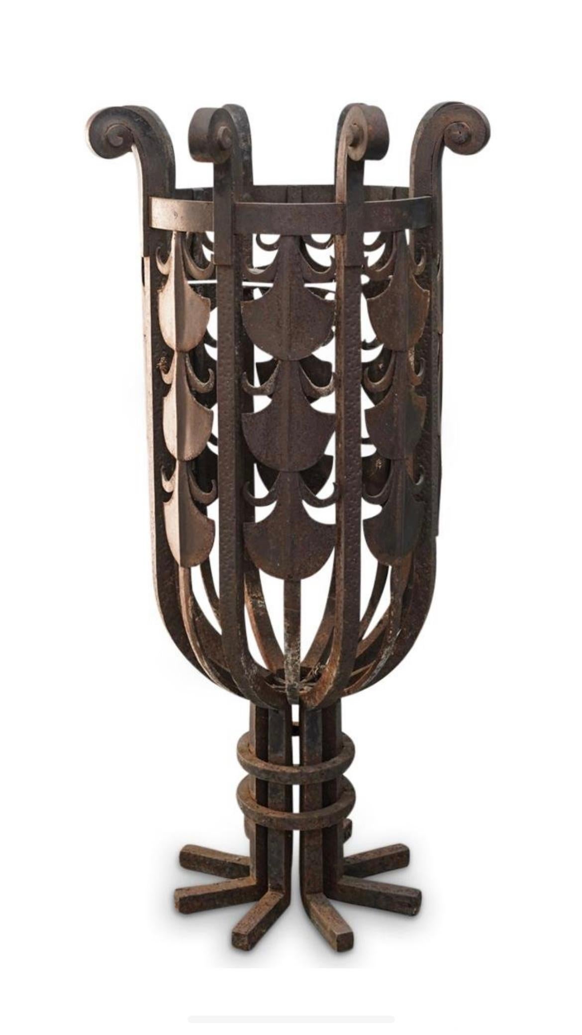 Our large, circular reticulated wrought iron planter from the Art Deco period features palm shaped motifs and c-scrolls. In the manner of Edgar Brandt.