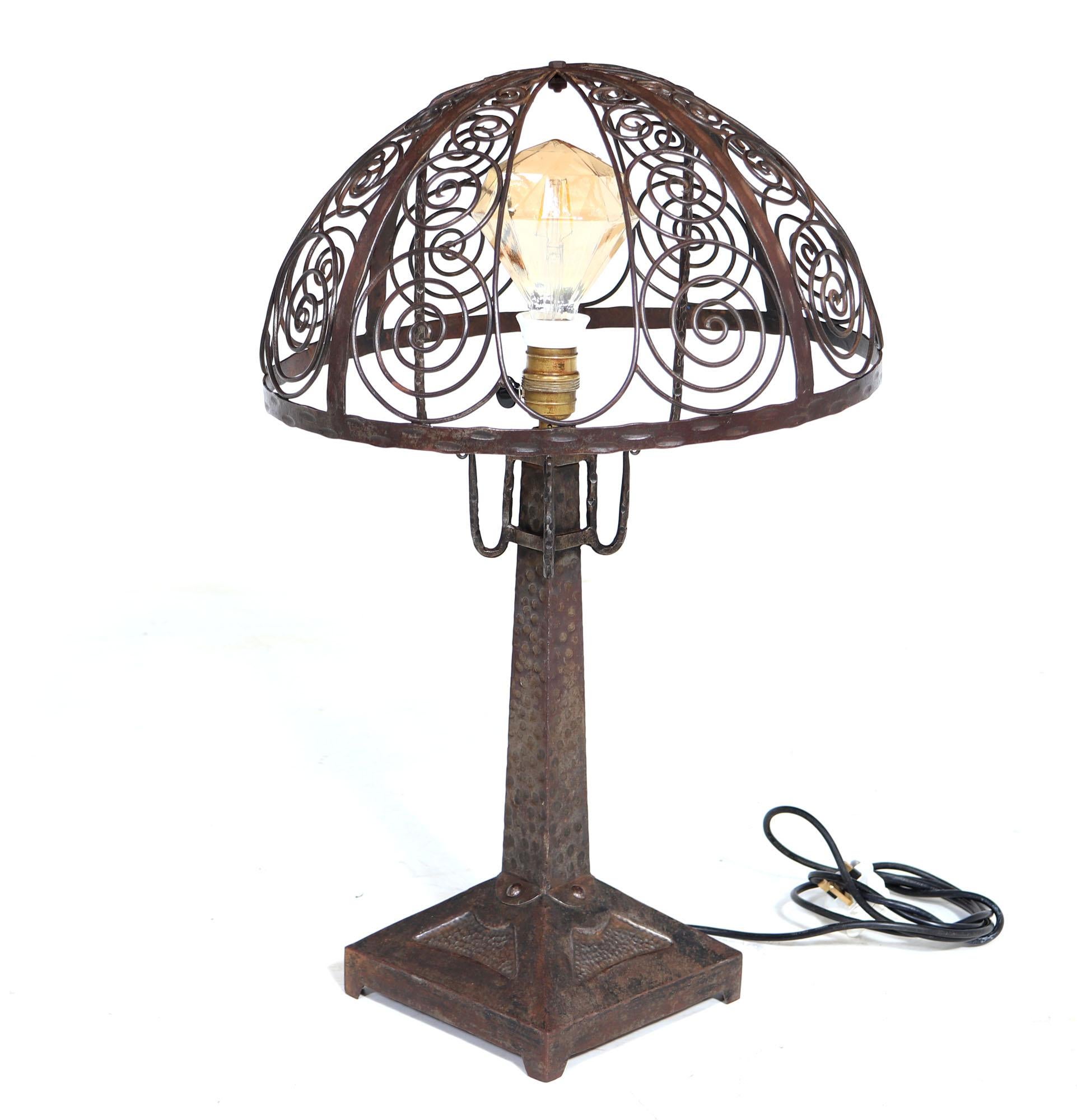 ART DECO LAMP
A very impressive and unusual Wrought iron table lamp produced in France in the 1930’s standing on an angular upright base with hammered detail the lamp has a good sized open ironwork top. This has never had fabric or glass attached