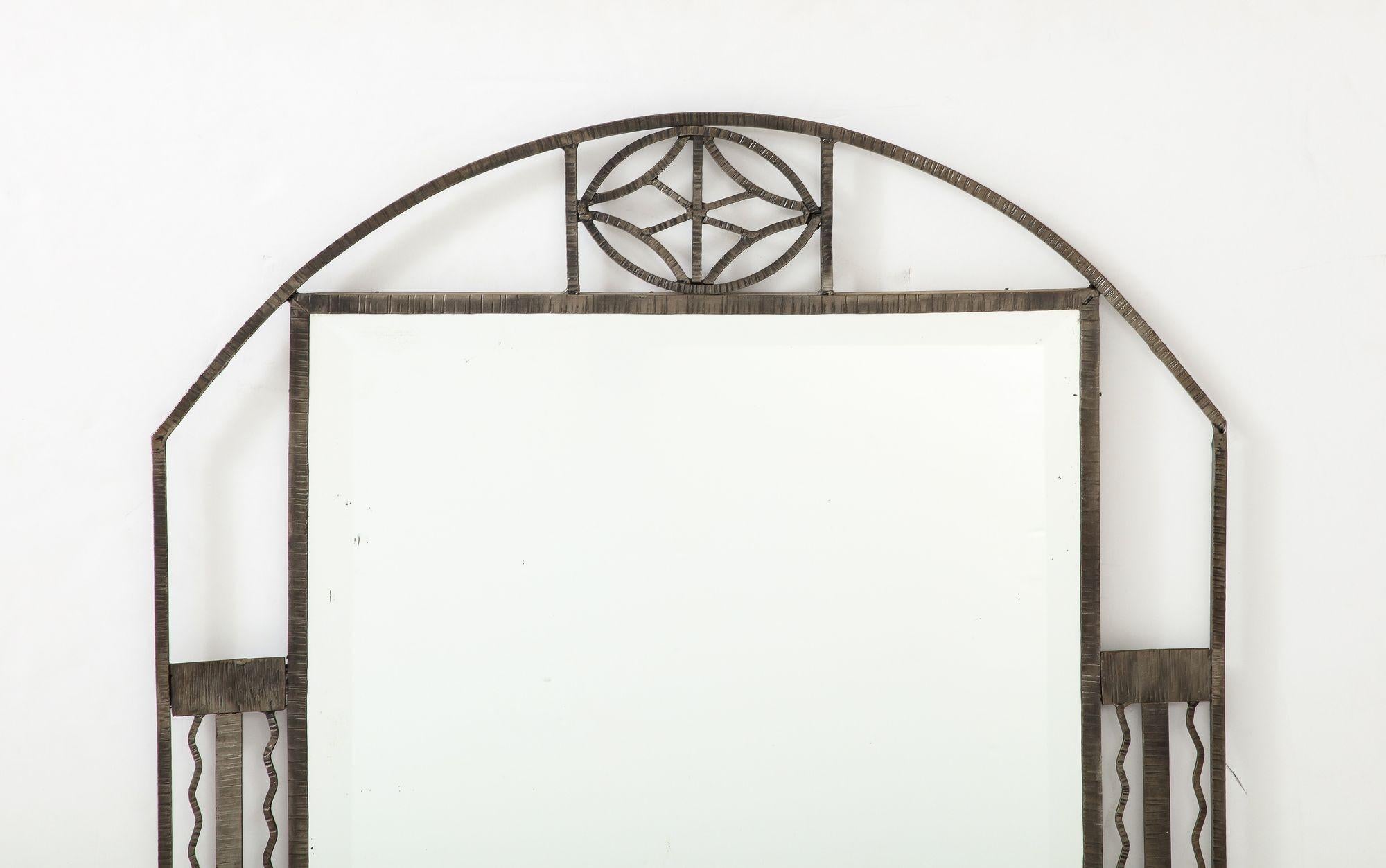 Muller Freres attributed Art Deco wrought iron mirror, the arched wrought iron top centering a motif, the sides with geometric patterns, centering a rectangular beveled mirror plate. 43