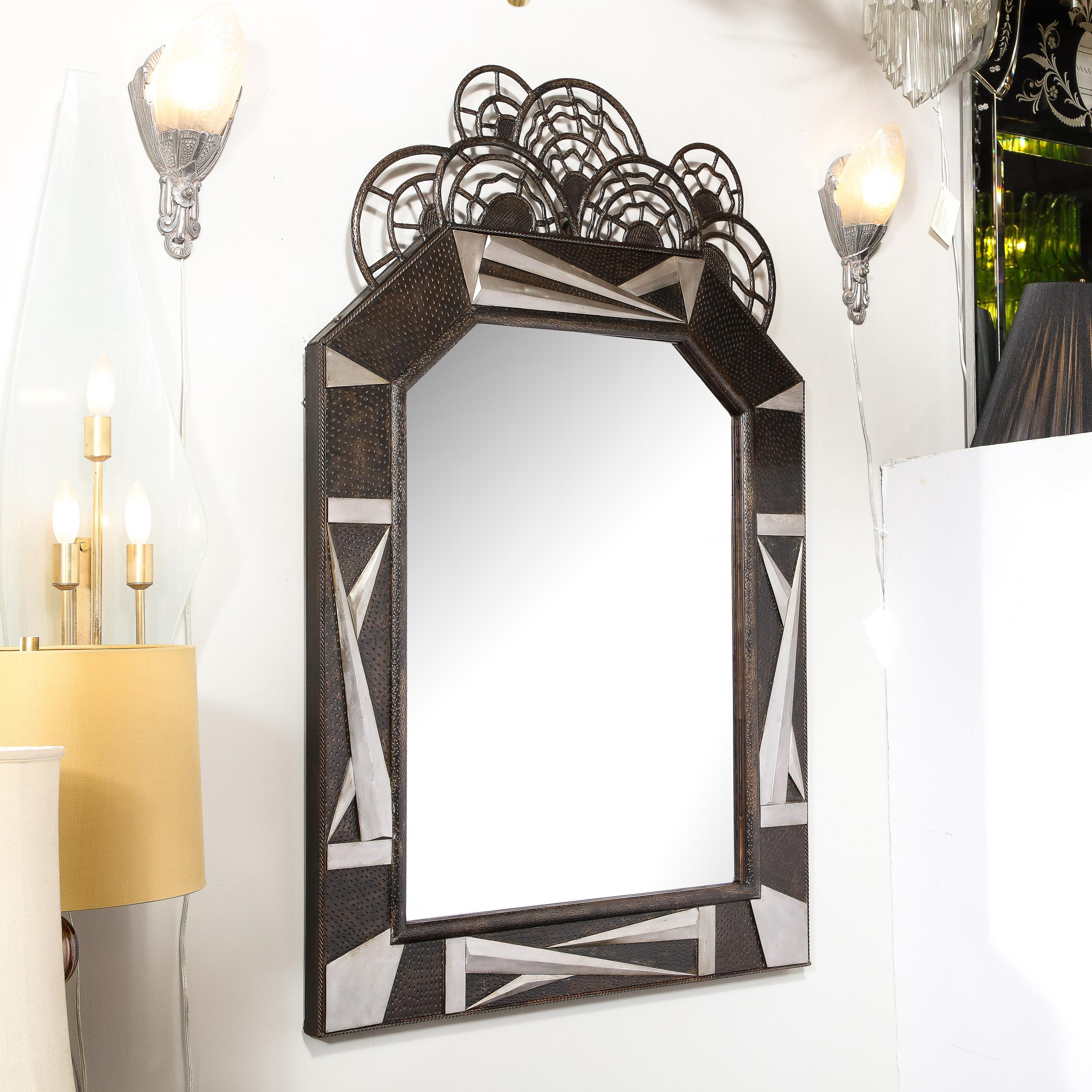 This Art Deco Wrought Iron Mirror with Highly Stylized Cubist Detailing and stylized geometric Floral Elements originates from France, Circa 1930 and is truly a work of art. The piece features a faceted geometric triangle shard motif in brushed