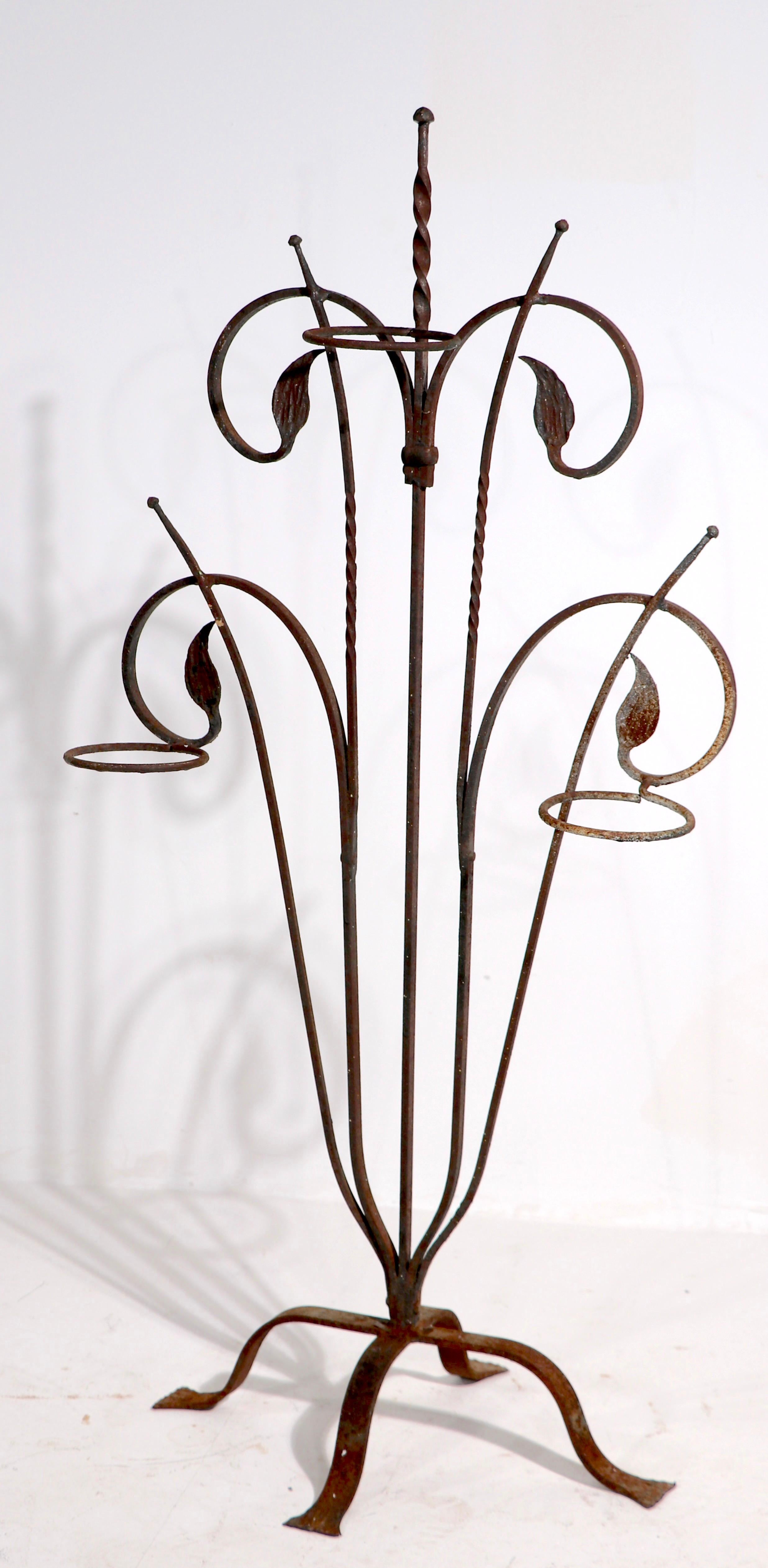 Outstanding hand wrought Art Deco plant stand attributed to Salterini. This example features three ring form plant holders each 4.5 in. dia. - foliate motif structure, original finish, shows surface rust, normal and consistent with age. Use as is,