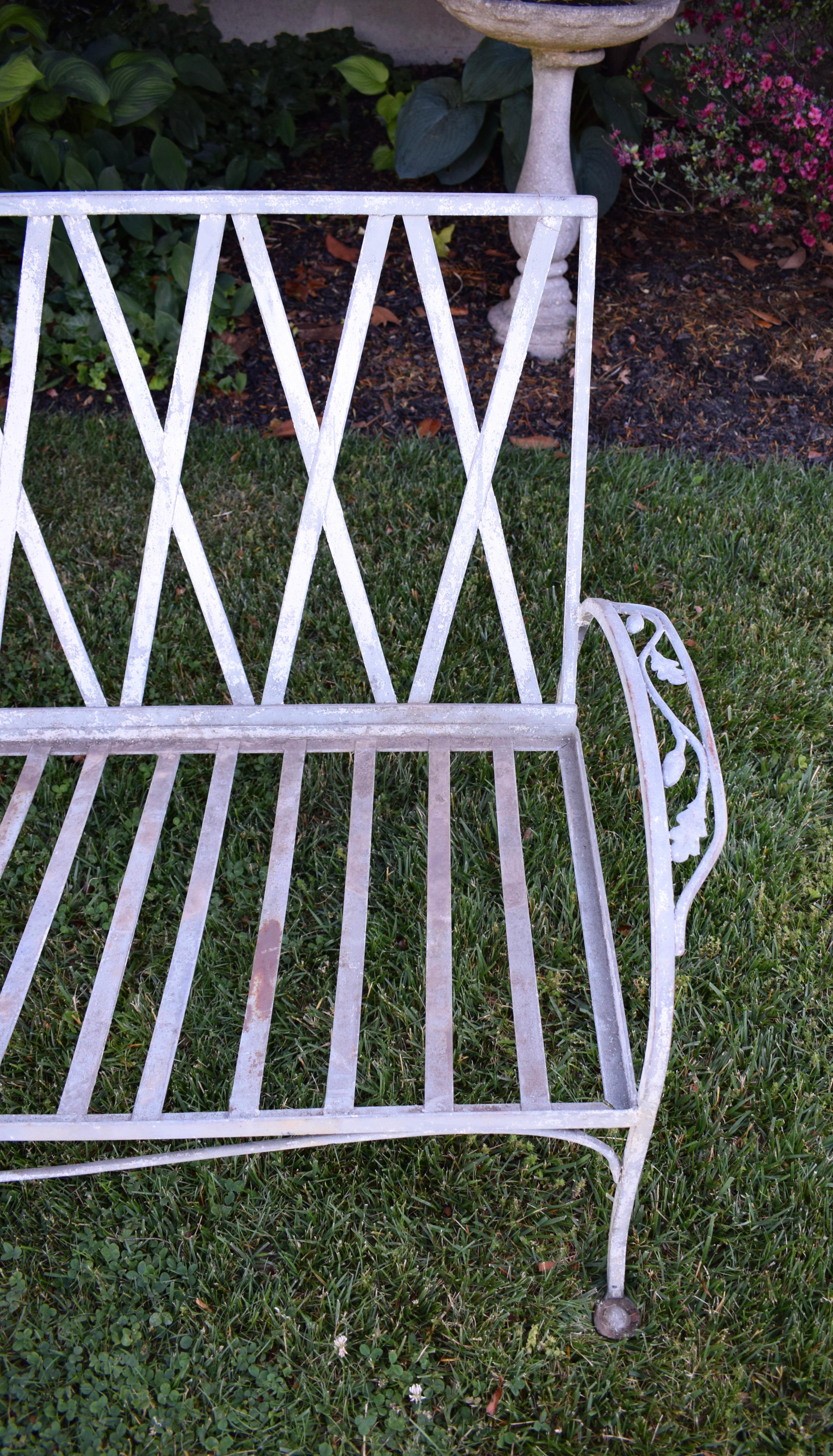 Wrought iron Outdoor patio sofa by Salterini, circa 1940's; Mount Vernon series in scarcely seen Oak Leaf & acorns pattern. Structurally sound and sturdy, the sofa shows signs of cosmetic wear to the naturally weathered  patinated paint finish.