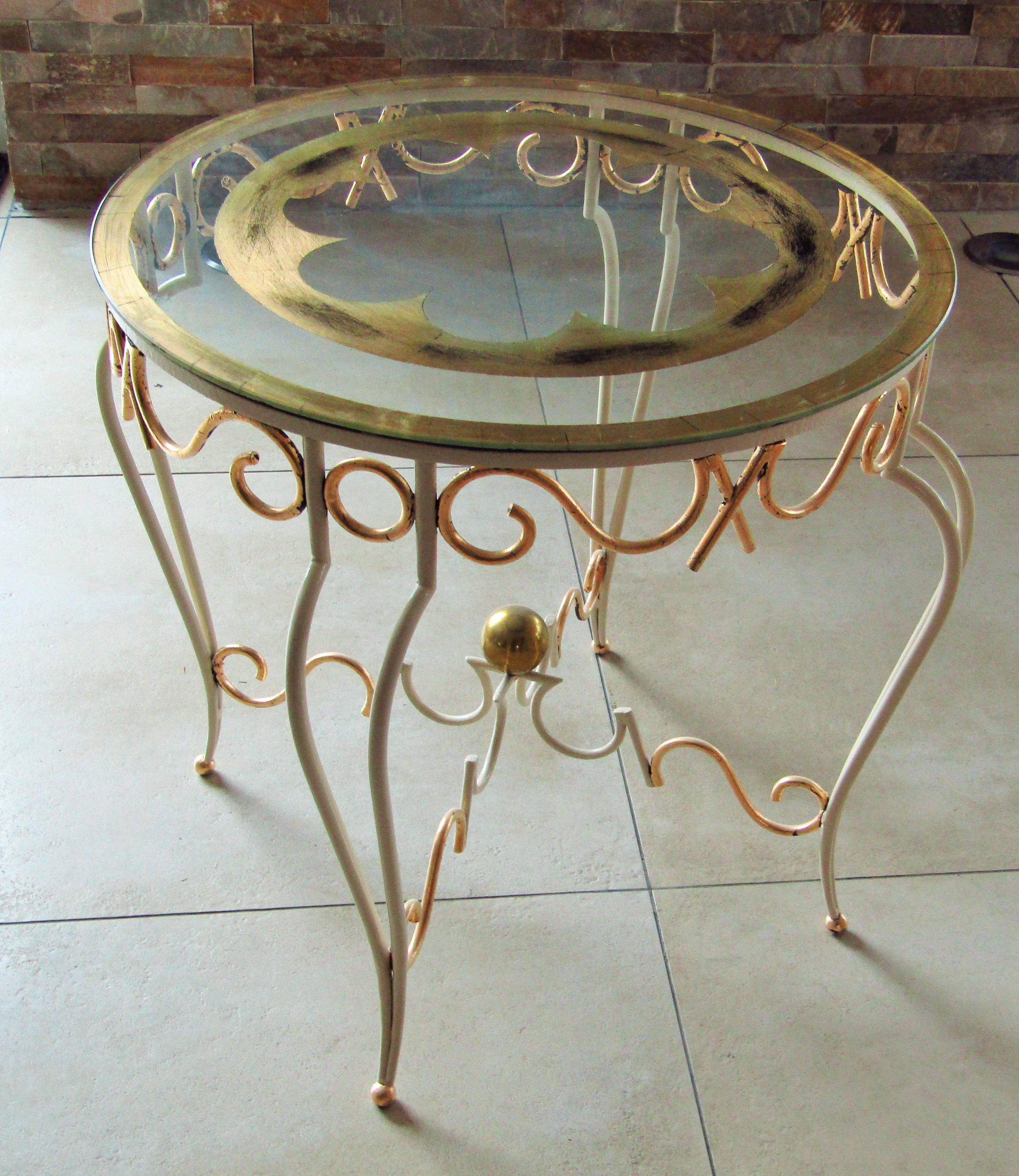 Art Deco coffee side table by Rene Prou, France 1935. Fully restored, wrought iron with ivory high gloss lacquer with gold leaf details. Glass tabletop with gold leaf details.

 