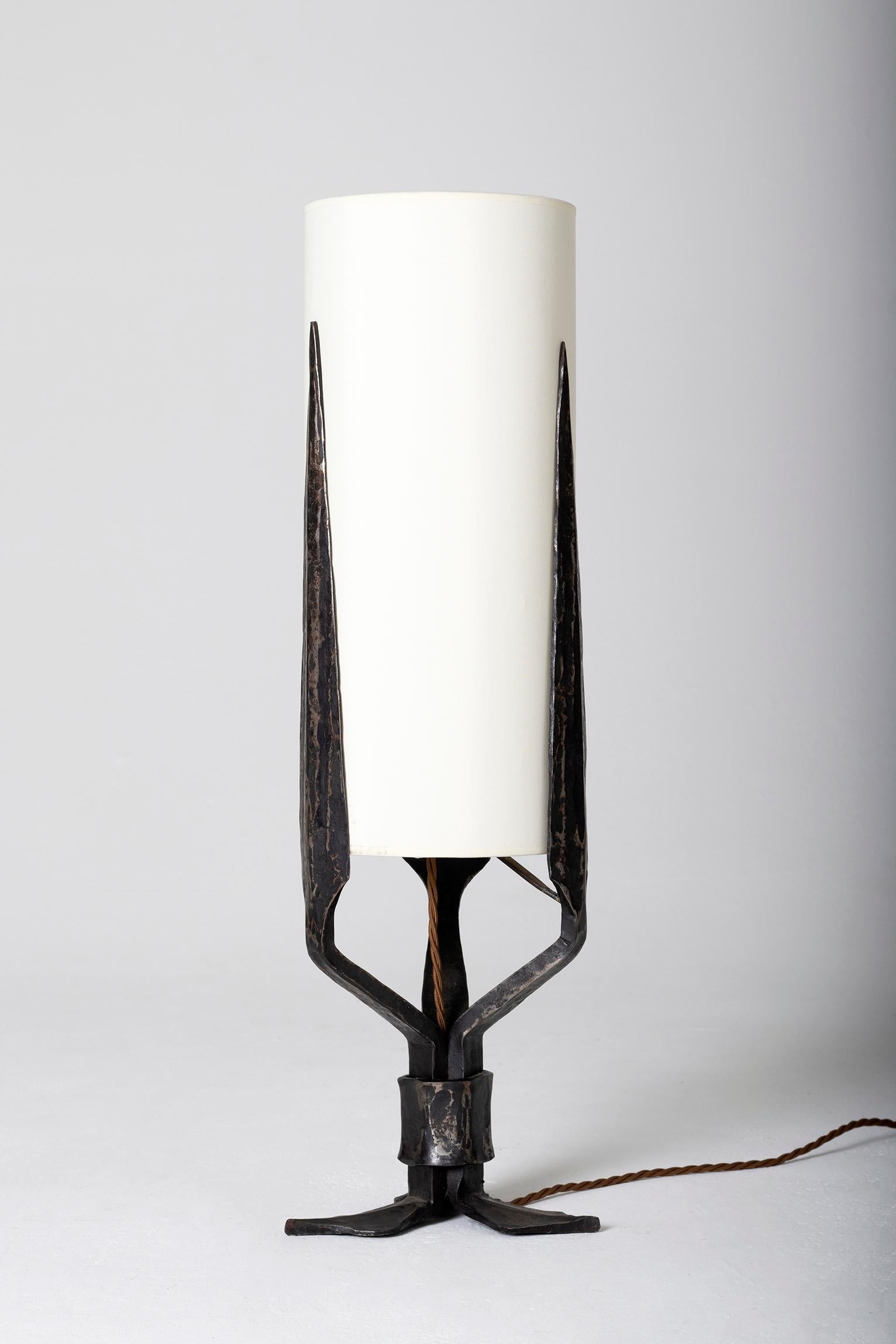 An Art Deco wrought iron table lamp, of stylized palms and leaves design
France, circa 1930.