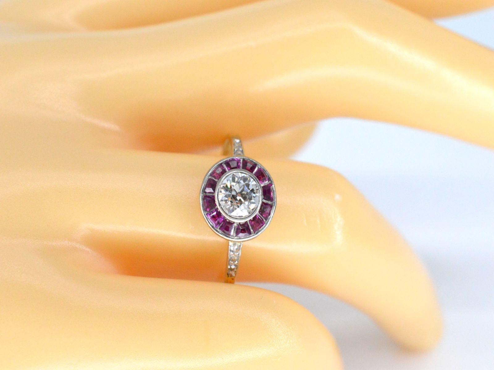 This vintage ring features a distinctive combination of diamonds and rubies, set in a classic design. The central diamond weighs 0.75 carats and is cut in an old-cut style, with a color grade of F-G and VS purity. Additionally, there are 8 smaller