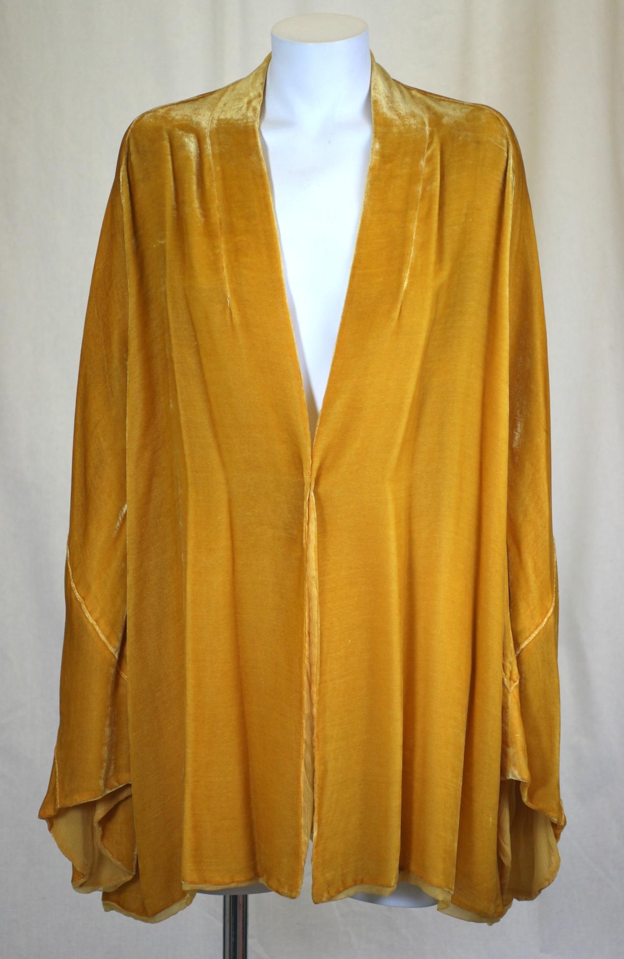 Dramatic Art Deco Yellow Silk Velvet Dressing Jacket from the 1920's retailed by L.P. Hollander. NY-Boston. Marigold yellow silk velvet is cut with dramatic Art Deco pieced sleeves and is worn open or wrapped. No closures.
Lined in fine silk