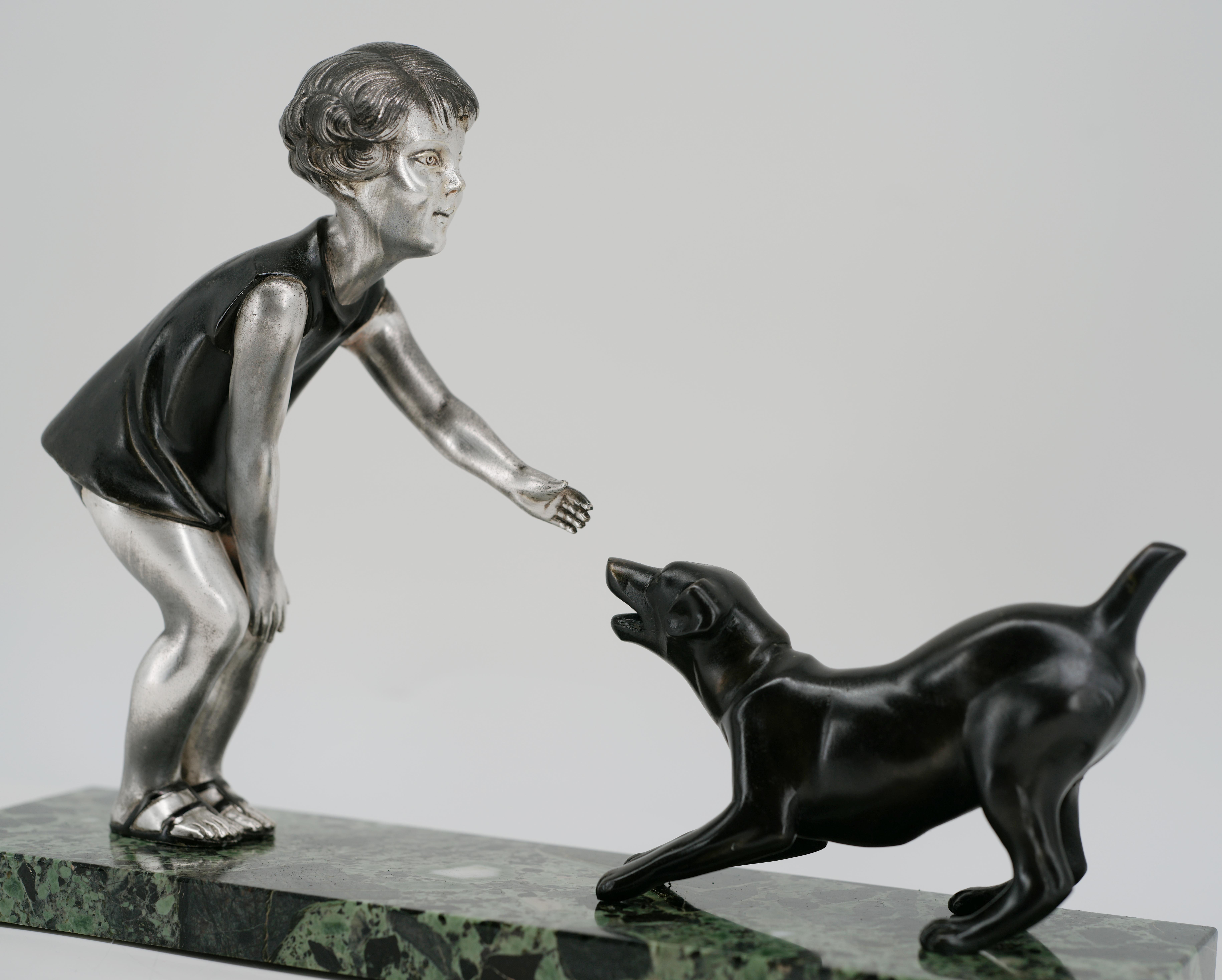 French Art Deco sculpture by P.Sega, France, 1920s. Young girl playing with a dog. Cold painted spelter and marble. Measures: Width : 13.1