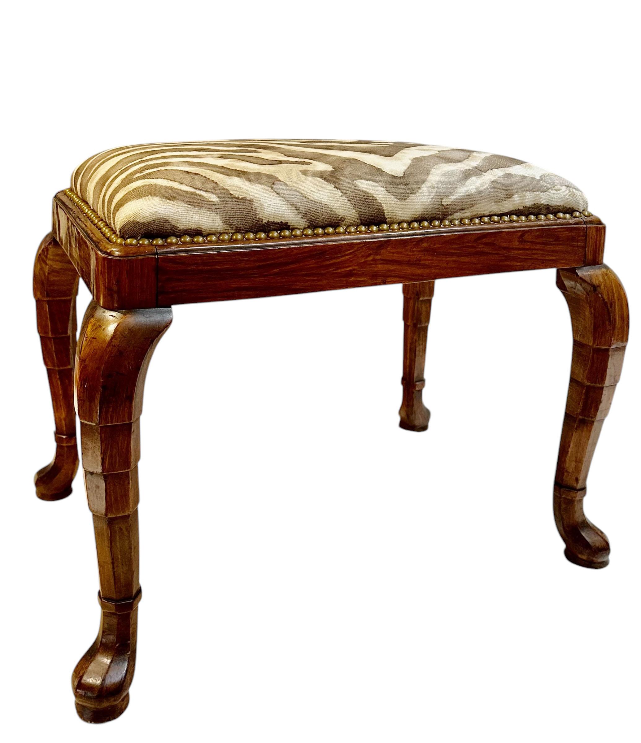 A very high quality walnut art deco bench with vintage Old World Weavers fabric and studded with nail heads. Has been completely restored. French, circa 1920s. 