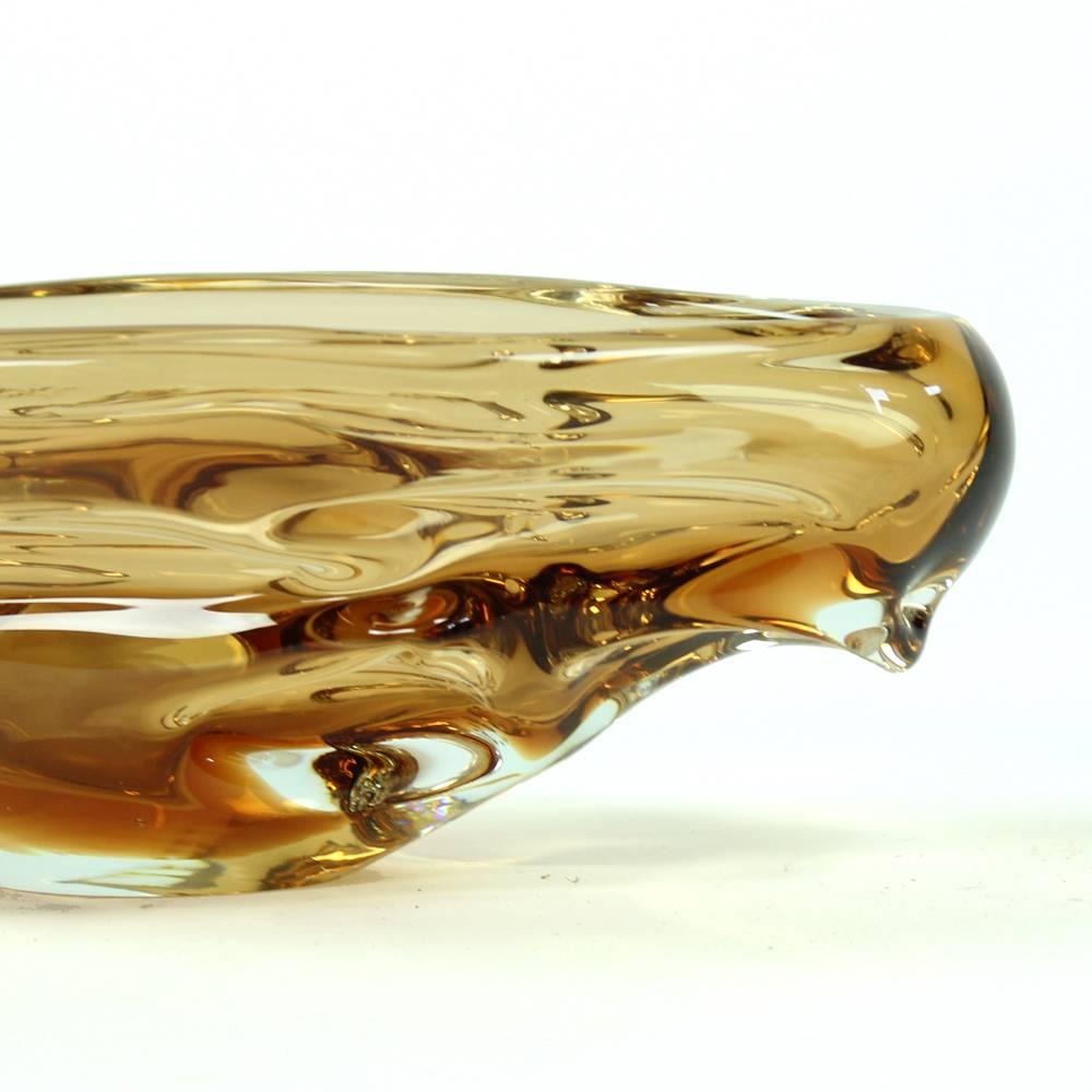 This impressive art glass bowl of amber glass created by Jan Beranek for Srkdlovice Glass company in Czech Republic. Beranek is one of the most impressive creators of beautiful glass items. This bowl is in an excellent condition.
  