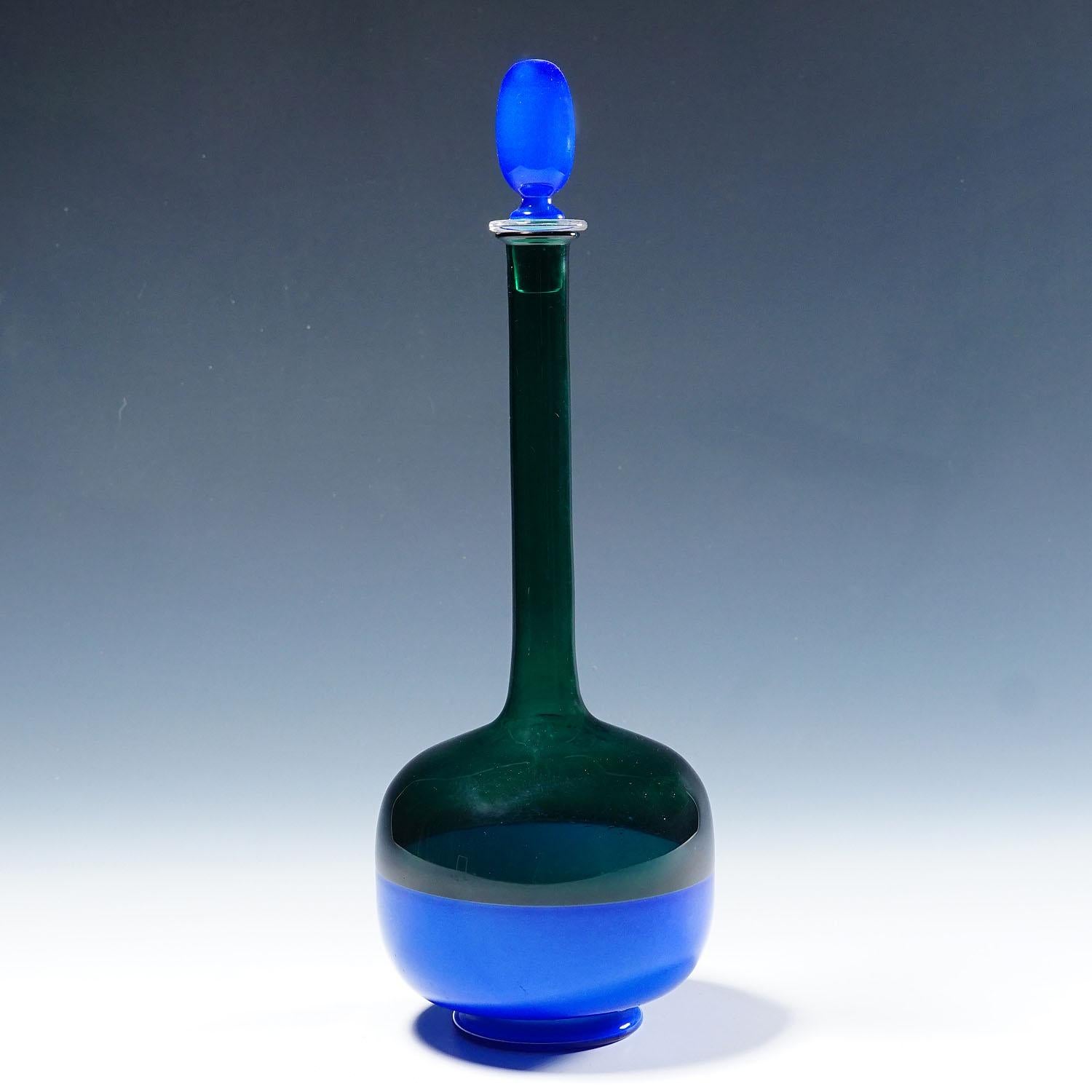 Art Glass Bottle Morandiana by Gio Ponti for Venini Murano

A vintage glass bottle in transparent green glass with blue stopper and a blue base fused in incalmo technique. Designed by Gio Ponti and manufactured by Venini Murano Venice ca. 1950s.