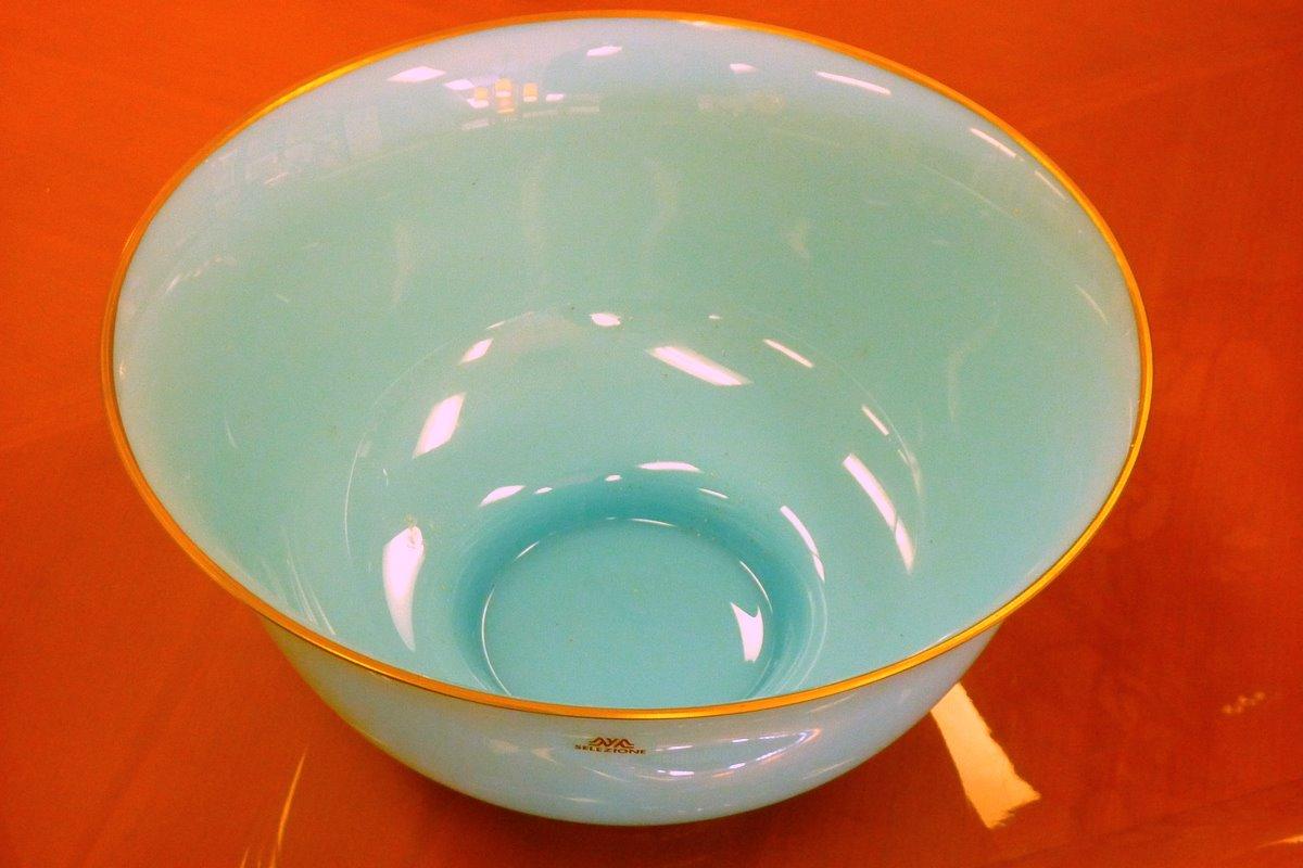 A lovely blue art glass bowl with a gold rim by Carlo Moretti for Selezione. Signed.

The reddish tint in the image is a reflection. The bowl is pure 