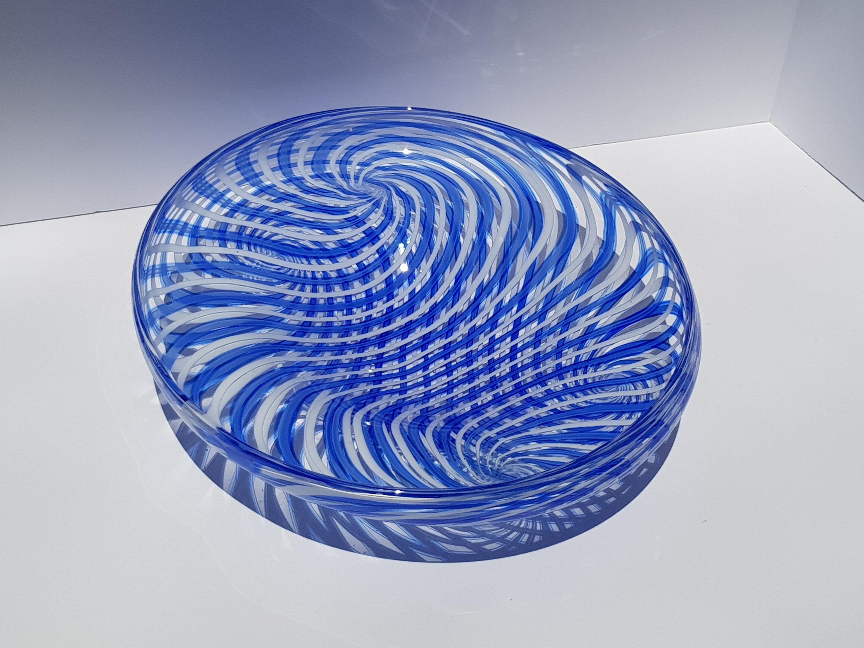 A fantastic modern art glass centerpiece bowl, dish or vessel made of the finest hand blown glass employing an unusual reticello type technique where blue and while ribbons or canes of glass are intertwined into a psychedelic modern masterpiece.