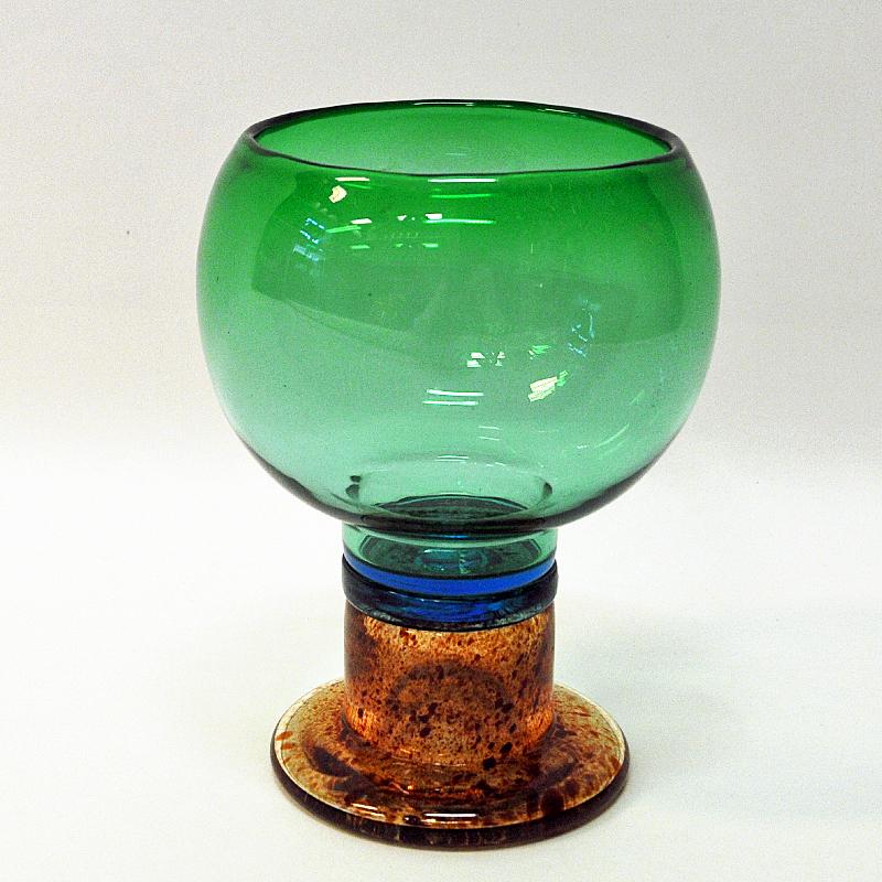 A lovely colorful pocal shaped goblet art bowl or vase designed by Kaj Franck for Nuutajärvi, Finland. This was produced from 1968-1971 and have a great combination of green, blue, red and clear color. Signed by Kaj Franck. Perfect vintage