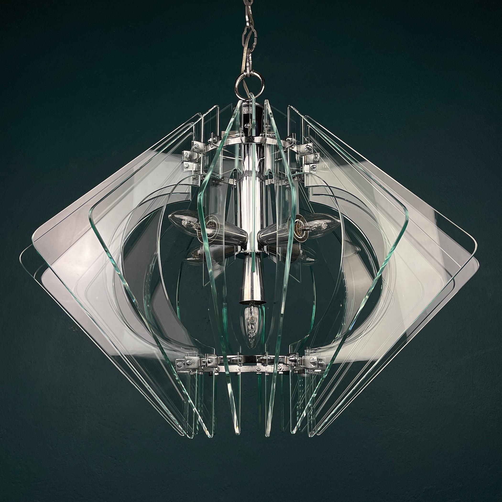 The beautiful Art glass chandelier by Veca made in Italy in the 1970s. The unusual shape, beautiful art glass creates a beautiful and effective light. Beautiful pale glass pieces have been shaped and highly polished with beveled ends to catch the