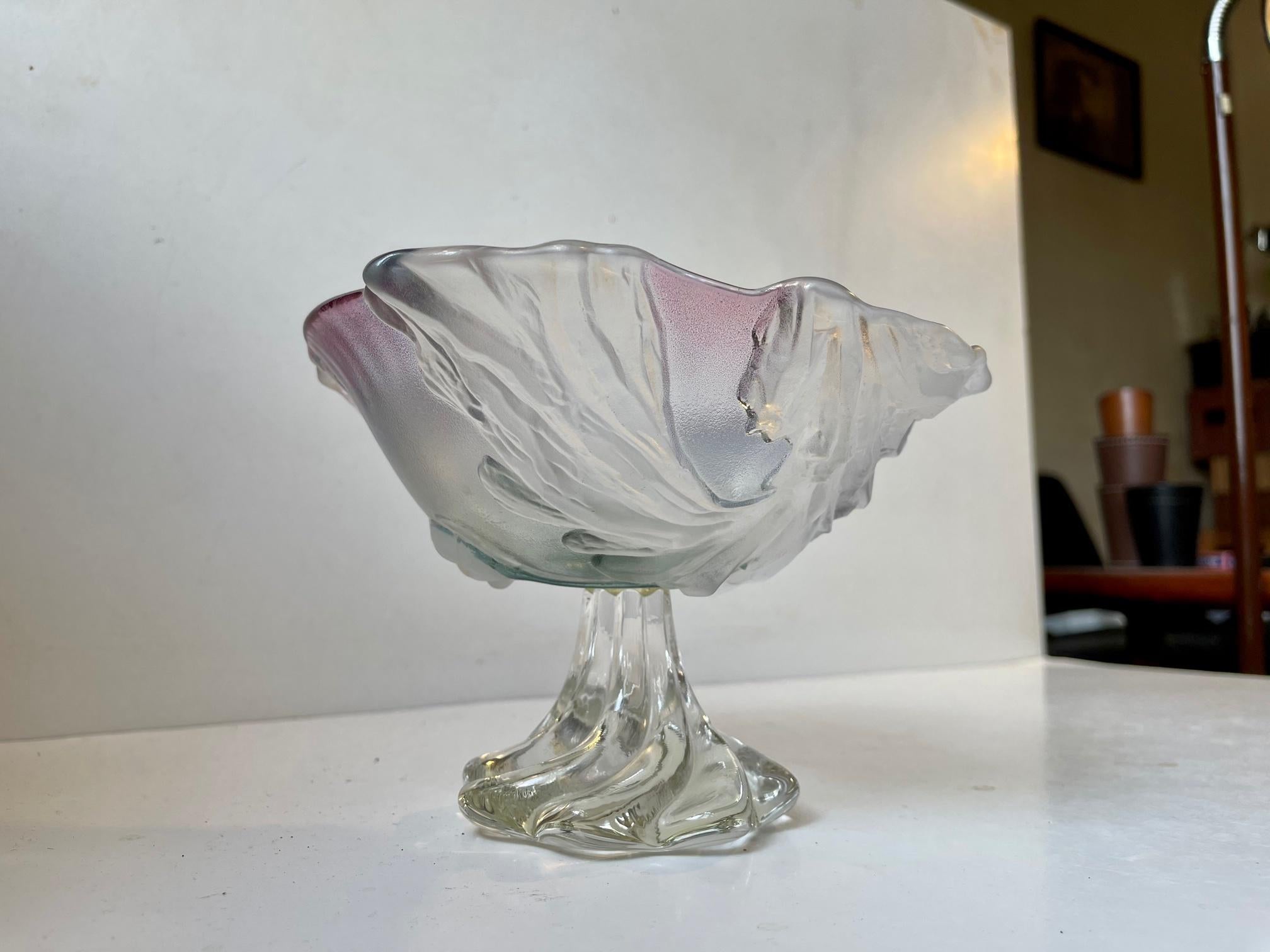 A delicate art crystal glass bowl free-form in shape and decorated with leaves and incapsulated splashes of pink and blue. It was made in France or Italy in a style reminiscent of Daum's Botanics series. It has no markings to its twisted base.