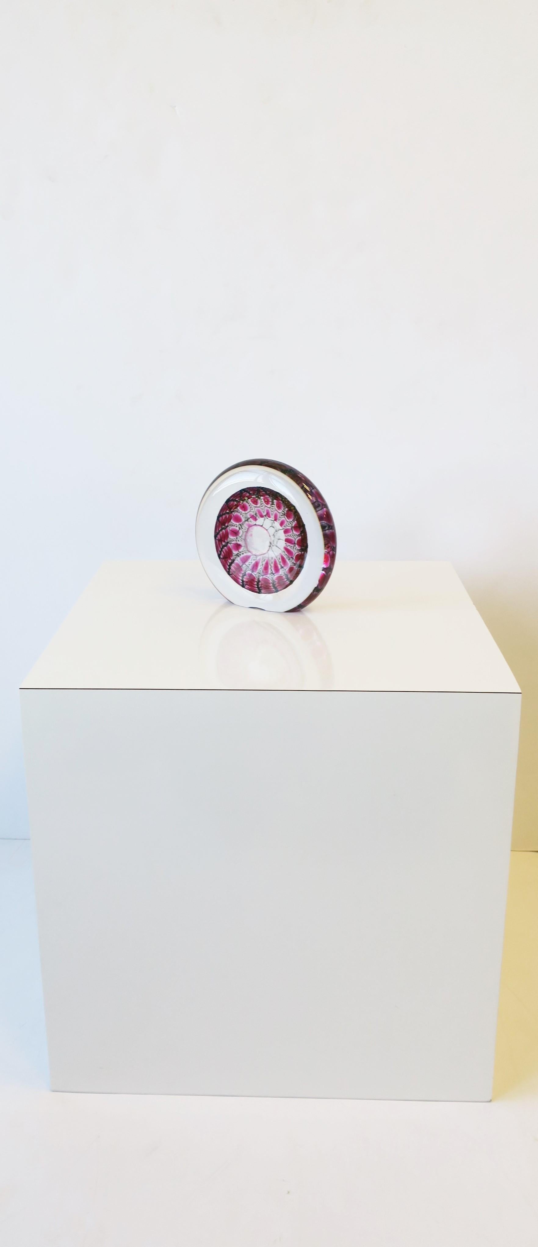 A beautiful and substantial round art glass decorative object, Contemporary period, 2011. Piece is signed and dated by artist on lower back area (please see image #11.) Art glass is transparent/clear with magenta pink/red raspberry and charcoal