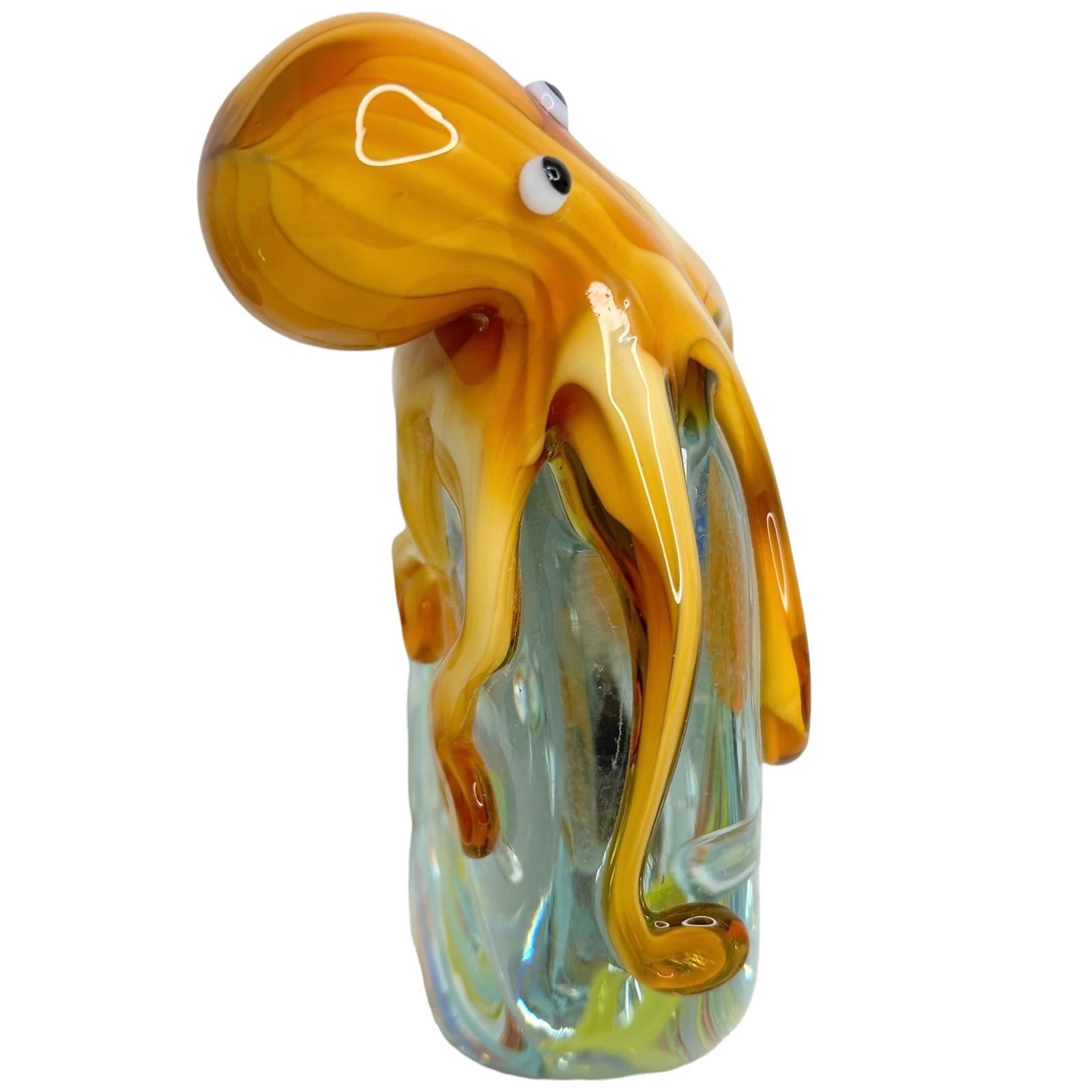 Beautiful Murano hand blown aquarium Italian art glass paper weight. Showing a giant octopuses on top of a Jelly Fish Aquarium, floating on controlled bubbles. Colors are a blue, yellow, orange and clear. A beautiful nice addition to your desktop or