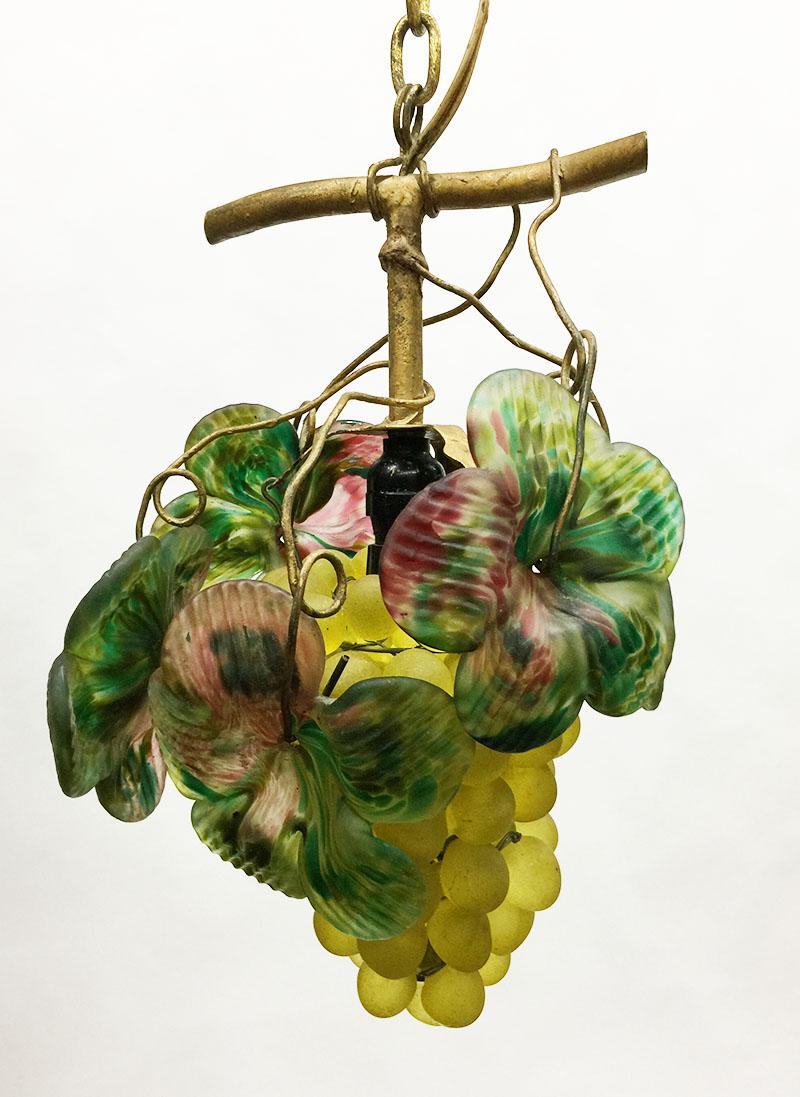 Art glass grape pendant lamp, 20th century

A bunch of grapes with leaves, made of  matted and colored glass
The bunch of grapes hangs on a metal chain
The pendant lamp measurements are 29 cm high and approximate 21 cm diagonal
The weight is 1502