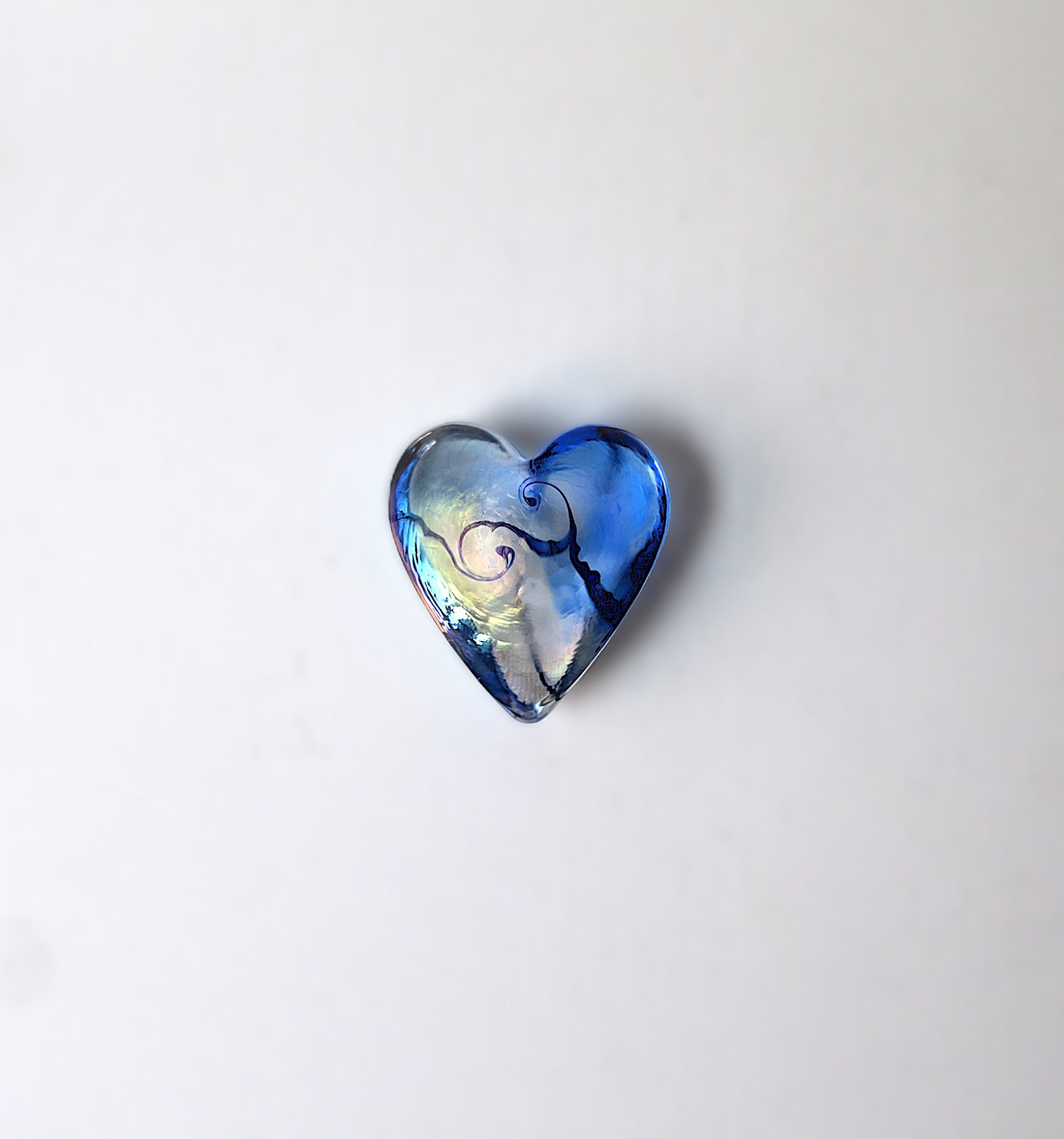 A beautiful and substantial art glass heart paperweight or decorative object by artist Robet Held, circa late-20th century. Heart is a light blue art glass with touches of blue and pink iridescence and swirls of blue. A great piece for a desk,