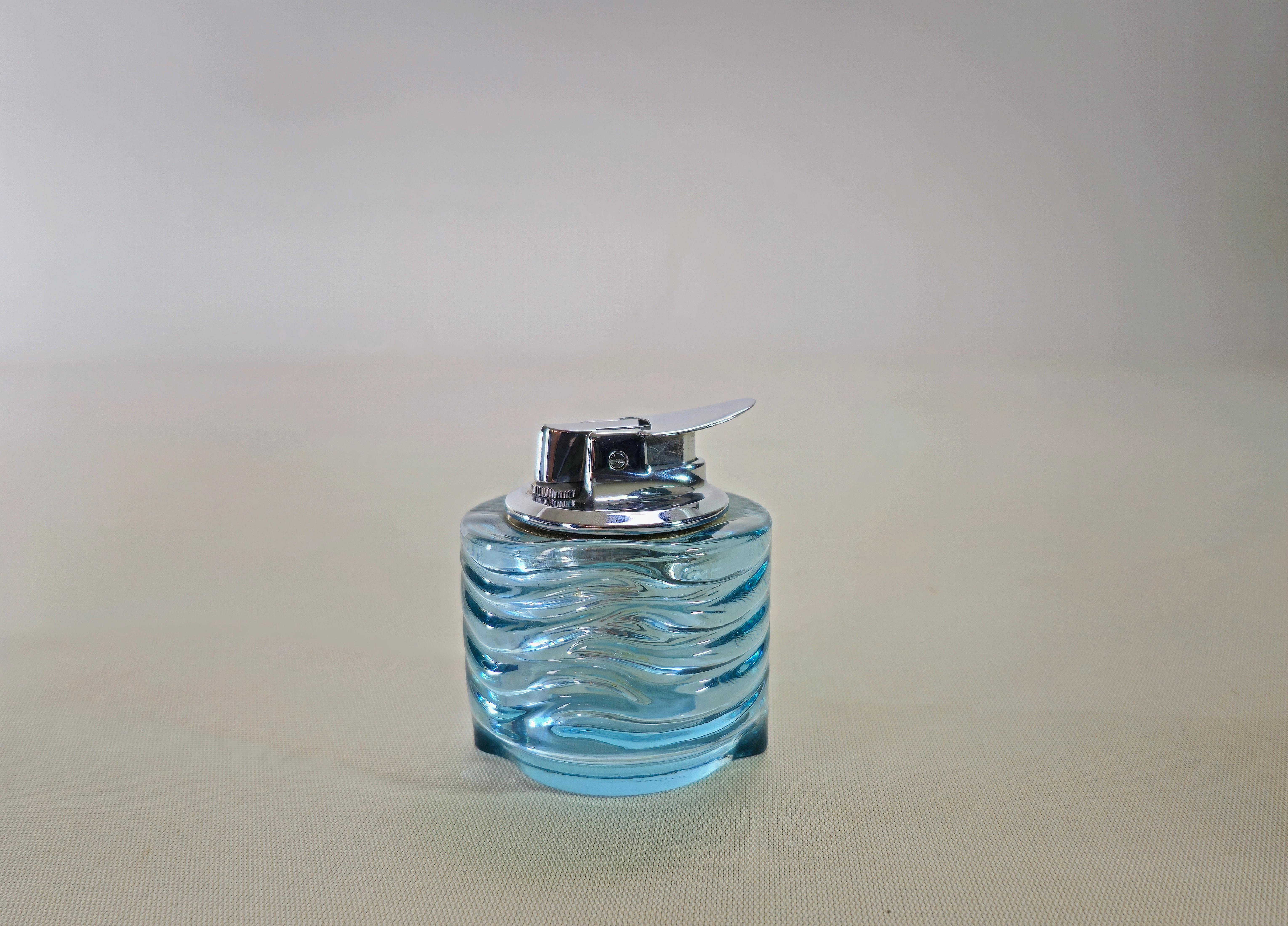 Design table lighter in Azteca glass in shades of light blue by Fabio Frontini and Arnolfo di Cambio from the 70s. Fits a revised and perfectly functional Ronson lighter.


Note: We try to offer our customers an excellent service even in shipments