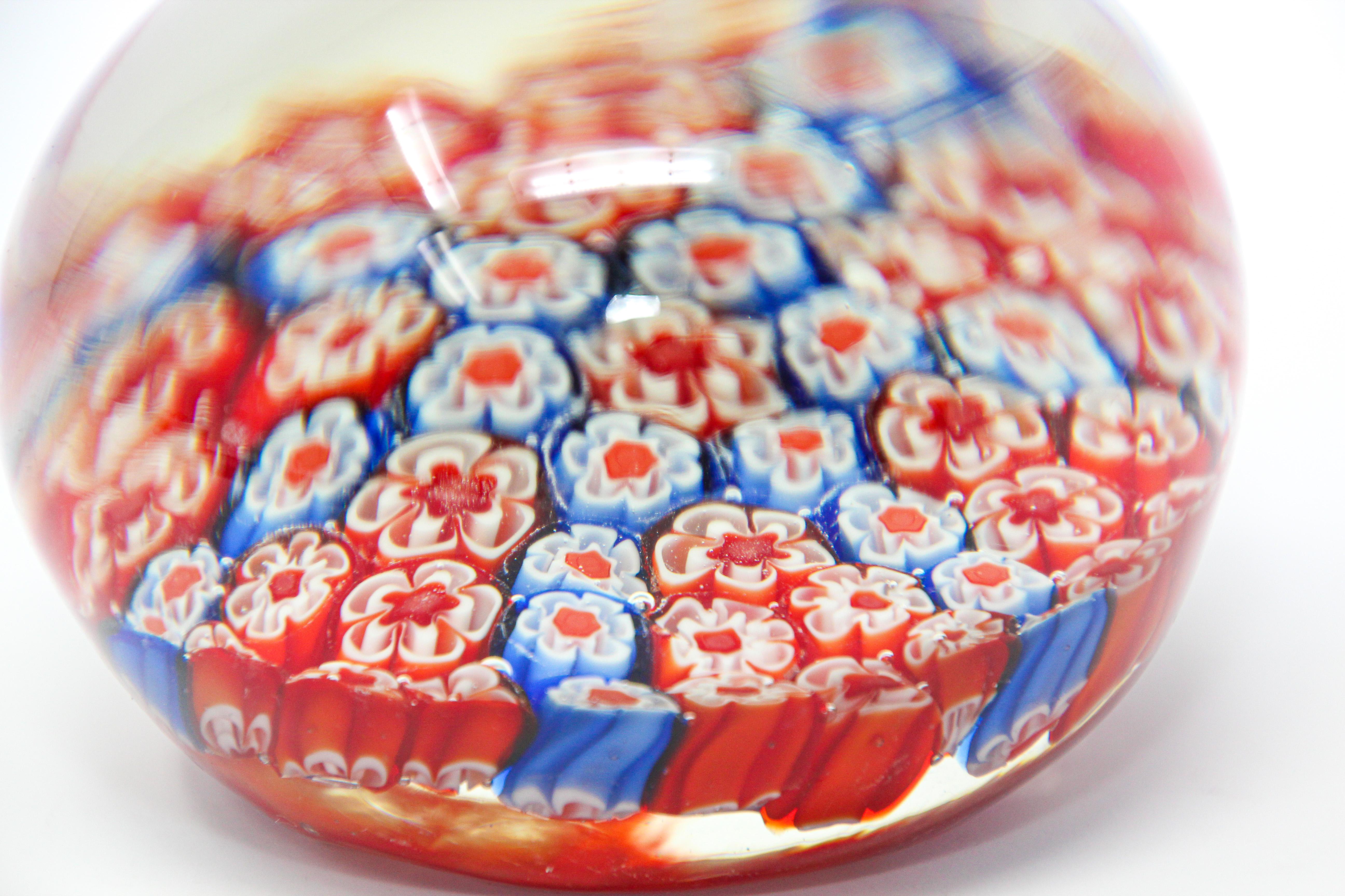 Millefiori Italian art glass paperweight
Beautiful glass art paperweight in millefiori design in various shades of blues, red and white, accenting the close concentric complex.
Murano glass hand blown in beautiful Millefiori (a thousand flowers)