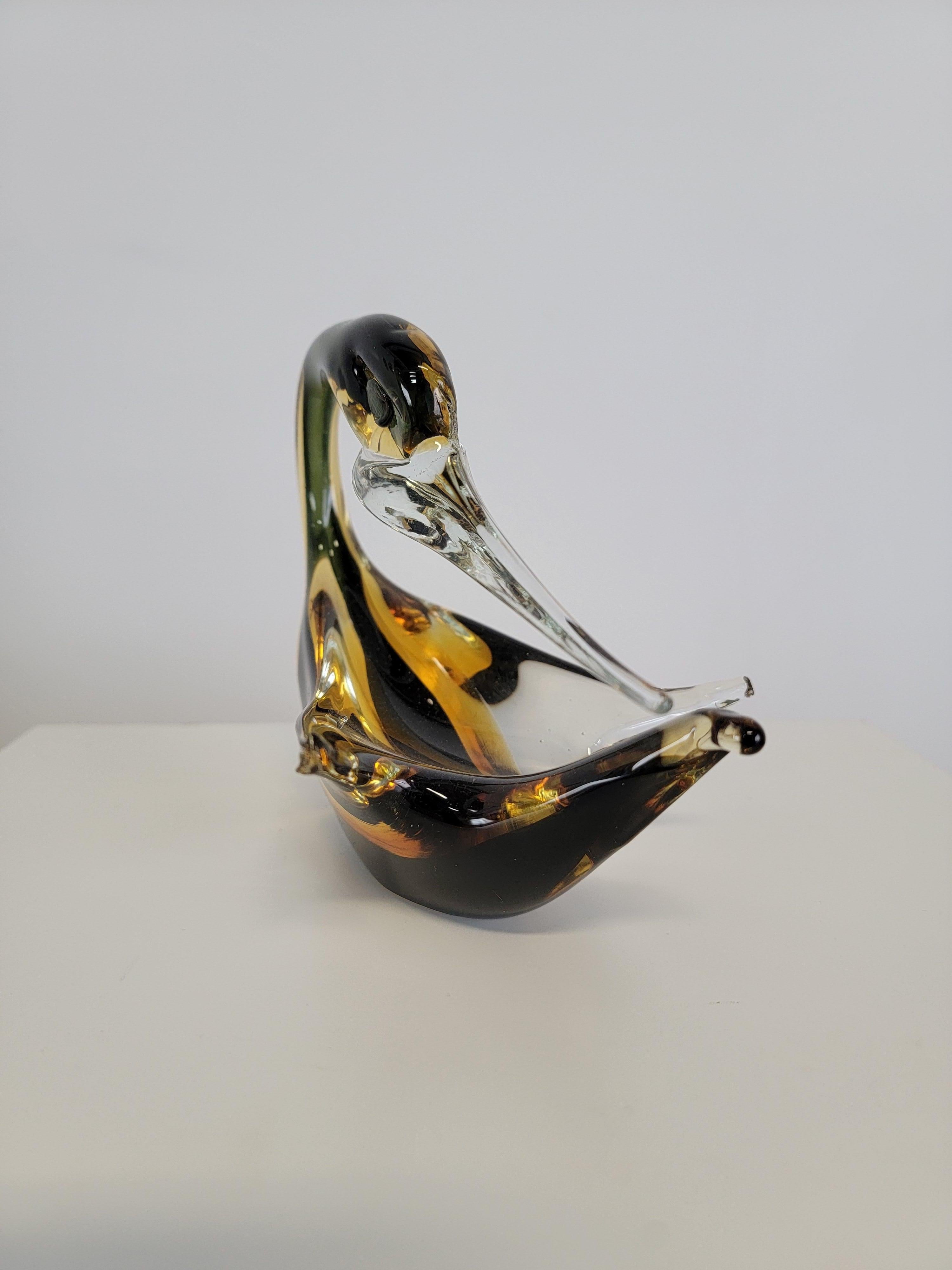 Beautiful art murano glass swan figurine. This art glass figurine was made using the Sommerso technique. This technique involves submerging a glass blown piece into crystal clear glass of a different colour. This art piece features yellow, black and