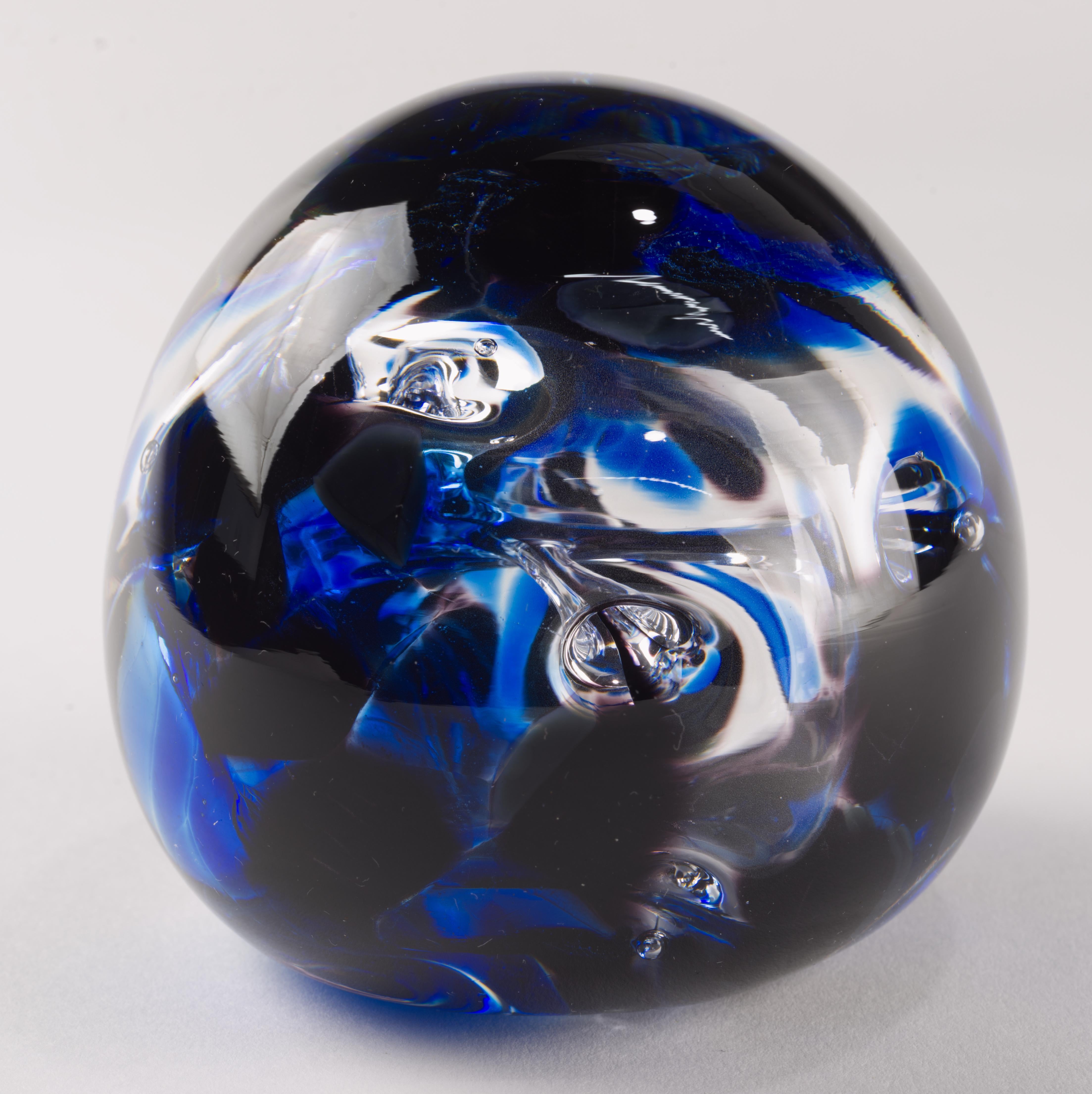  Large modern studio art glass paperweight in cobalt blue and clear glass with controlled bubbles forming an abstract biomorphic shaped element within the piece is handmade and signed by the artist on the bottom. 

The paperweight is 3