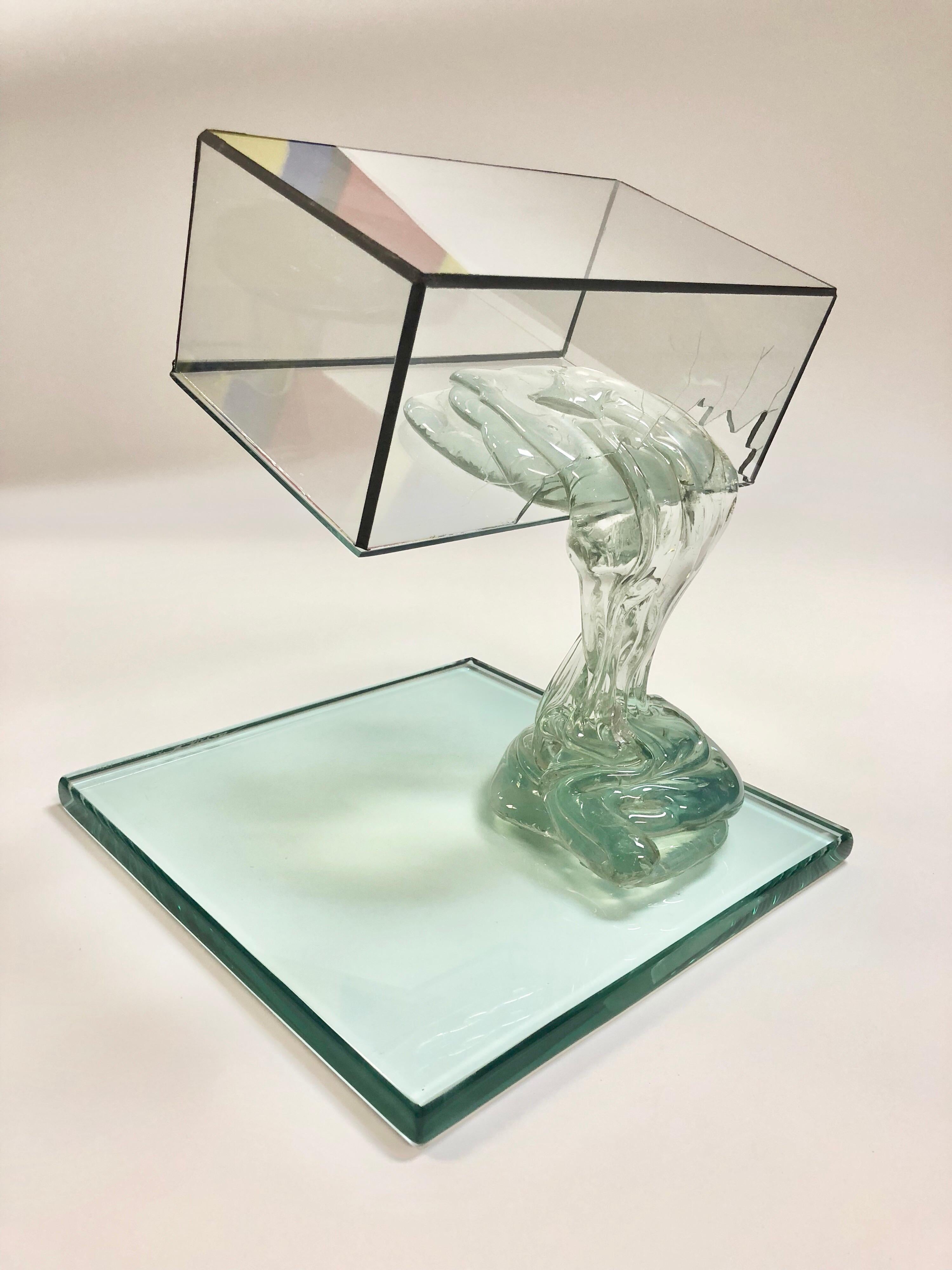 An all glass sculpture by master glass artist Drew Smith. Quite interesting, a liquid seems to spill from the broken box onto a lower surface.

Smith graduated with his B.A. from Ashland University in Ohio. He learned glass making from Henry Halem
