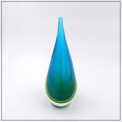 Art glass sculpture in the shape of a teardrop in shades of blue and green