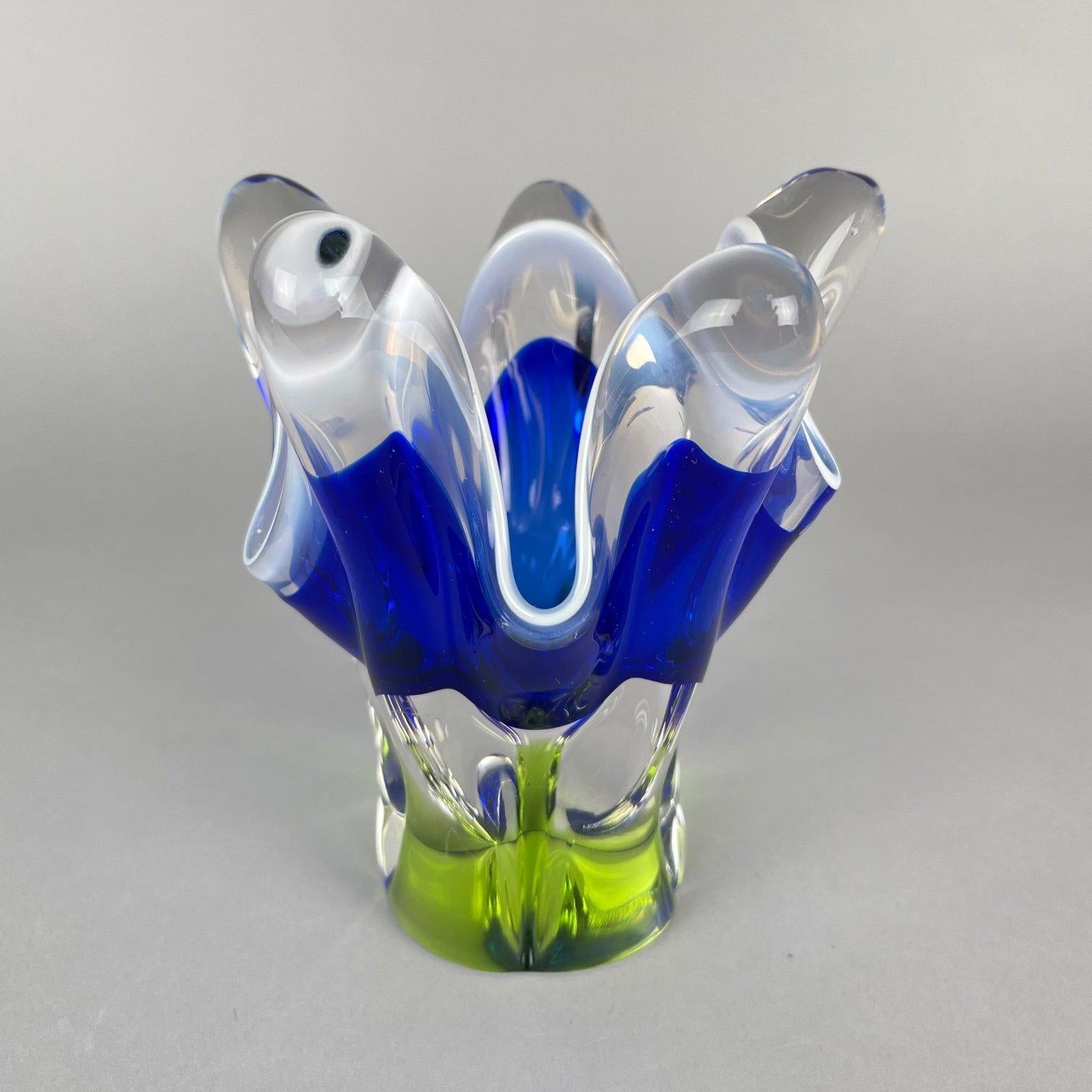 Beautiful Czech sculptural glass vase designed by Josef Hospodka in 1960's and made by the Chribska Glassworks. Combination of blue, green and clear glass with a lovely opaque white rim. 
Good vintage condition with some signs of use (see photo).