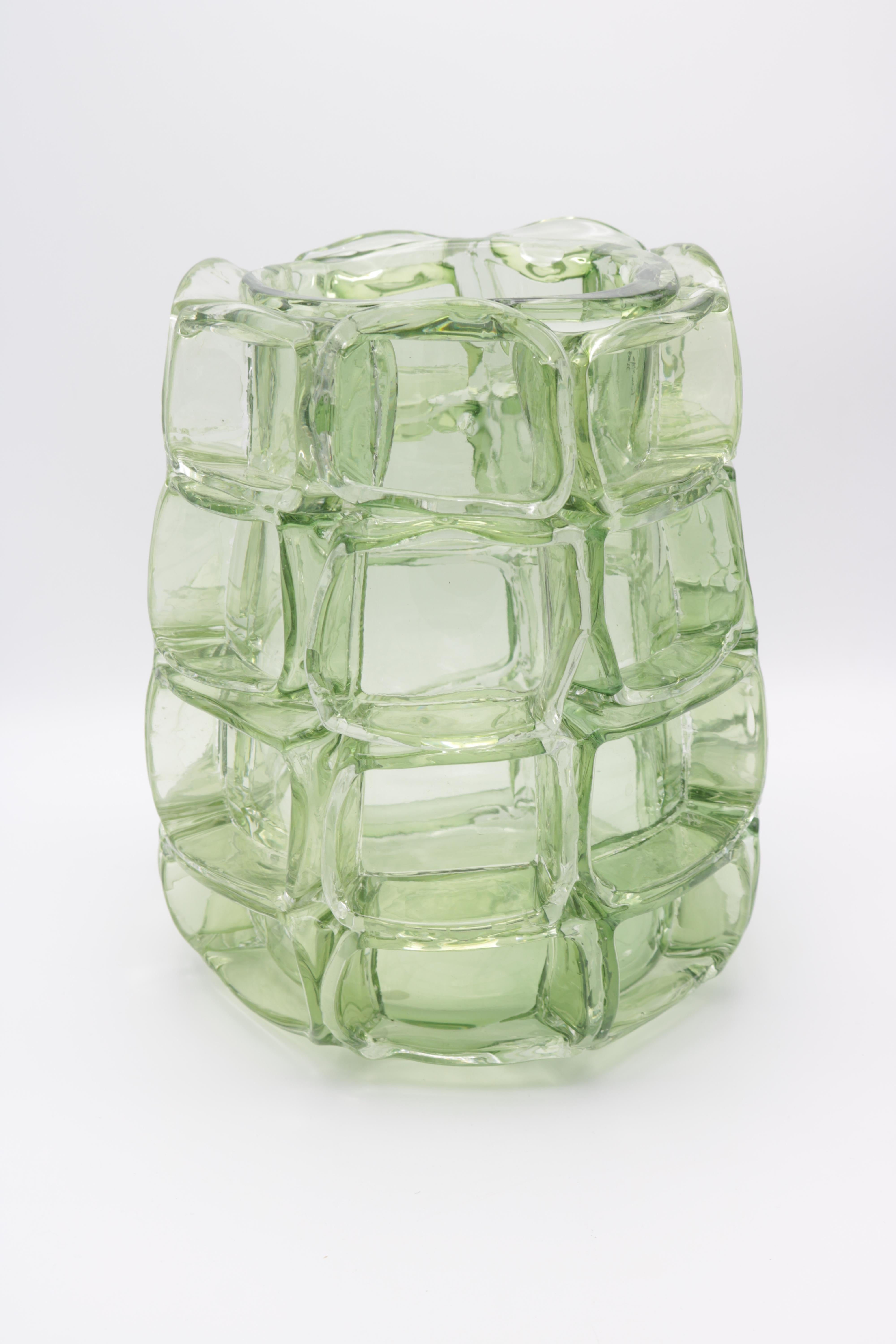 An art glass vase by Martin Potsch. 
Green glass surrounded with square green prunts.
Etched signature on the bottom.