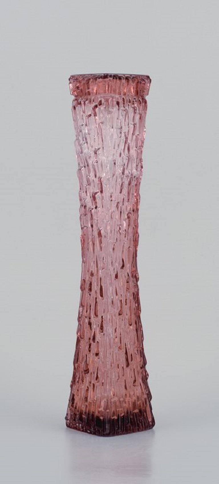 Art glass vase, Central Europe. Tall and slim vase in modern design in purple glass.
Mid-20th Century.
In perfect condition.
Dimensions: H 34.5 x D 7.0 cm.