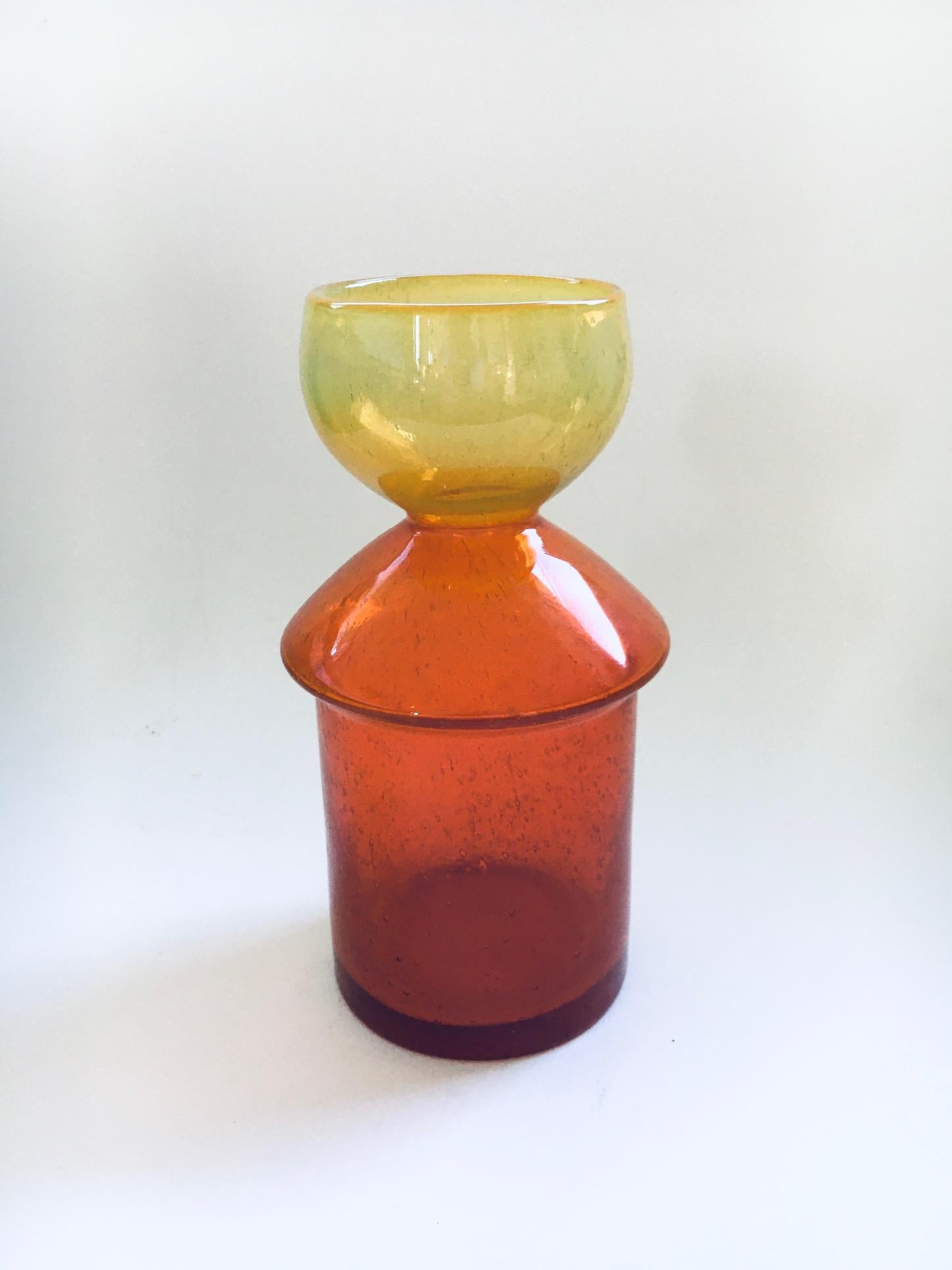 Vintage Midcentury Design Art Glass Vase in orange and yellow. Made in France, 1960's period. Handblown art glass with bubbles inside. No markings on the bottom, only a pontil mark. Beautiful geometric shape. This comes in very good condition.