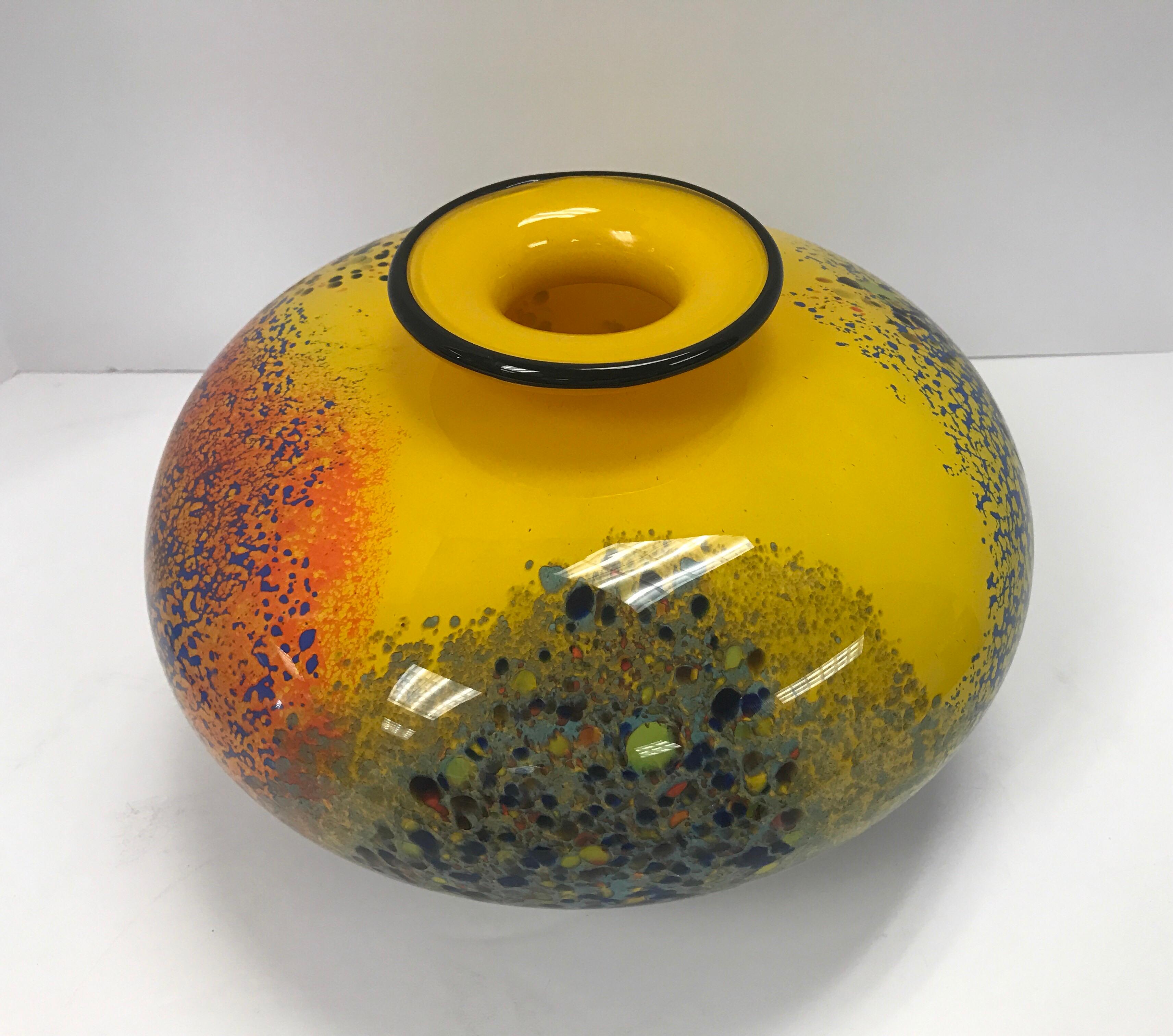 A beautiful handblown studio art glass vase by Romanian glass artist, Ioan Nemtoi. No two pieces are exactly alike and this piece, like all of his work, is of heavy glass and stunning with its clarity and color. A gorgeous Nemtoi piece indeed, this