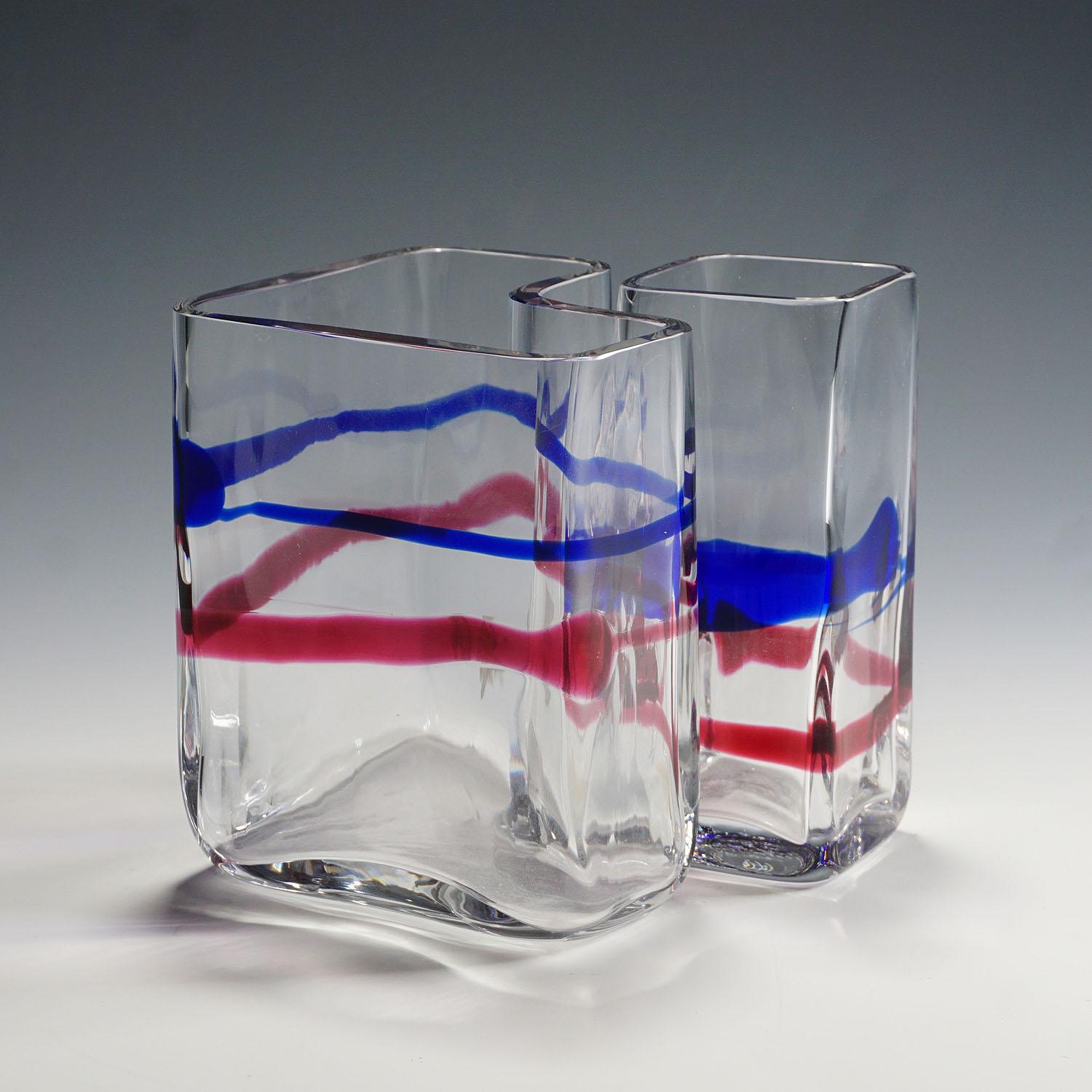 Pair of rectangular art glass vases designed by Erick Hoeglund for Vrigstad Glassworks ca. 1980s. Clear glass with fused ribbons in red and blue. Marked with company lable and signature on the base: 'Vrigstad Kristallhytta Erik Hoeglund' and model