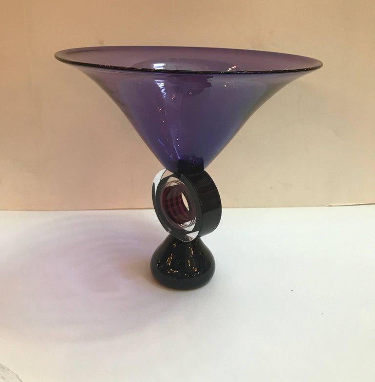 A tall modern trumpet form centre bowl with unusual pedestal base having a circular stem with bands of colored glass resting on a black solid glass cone. The piece is signed and numbered limited edition of 500. The artist signature is illegible but