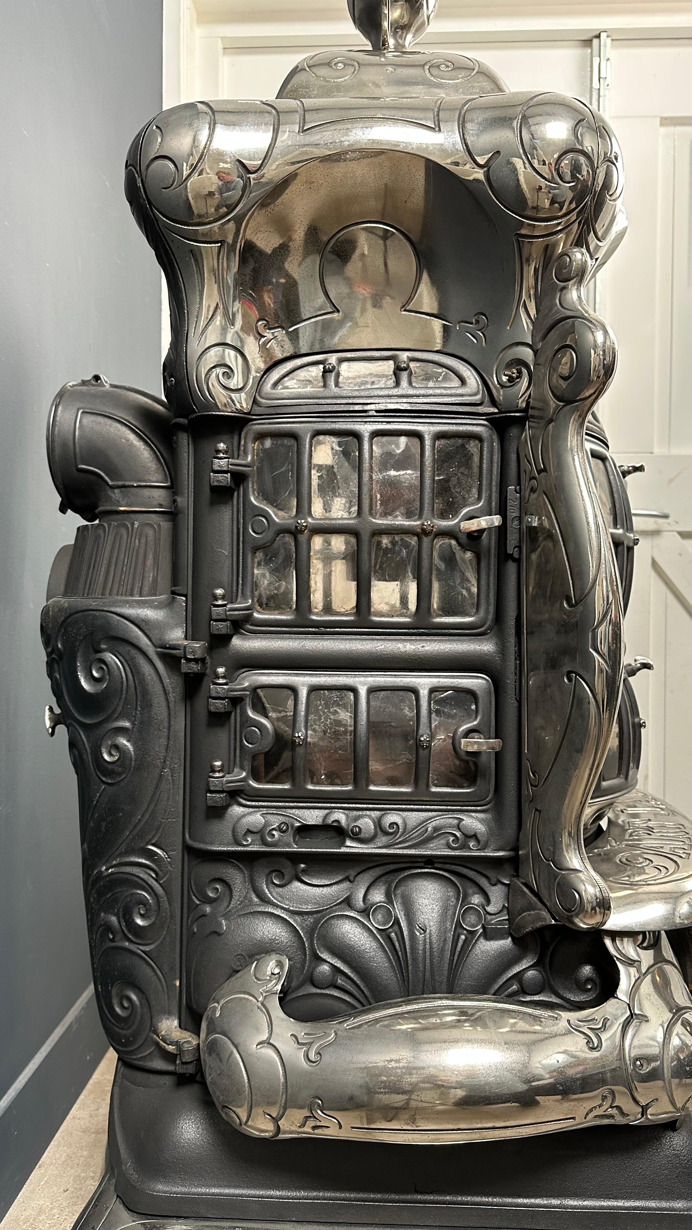 Presenting an exquisitely crafted Art Laurel wood stove, resplendent in its pristine condition. This extraordinary piece captivates the observer with its aesthetic brilliance. The intricate details woven into its design and embellishments attest to